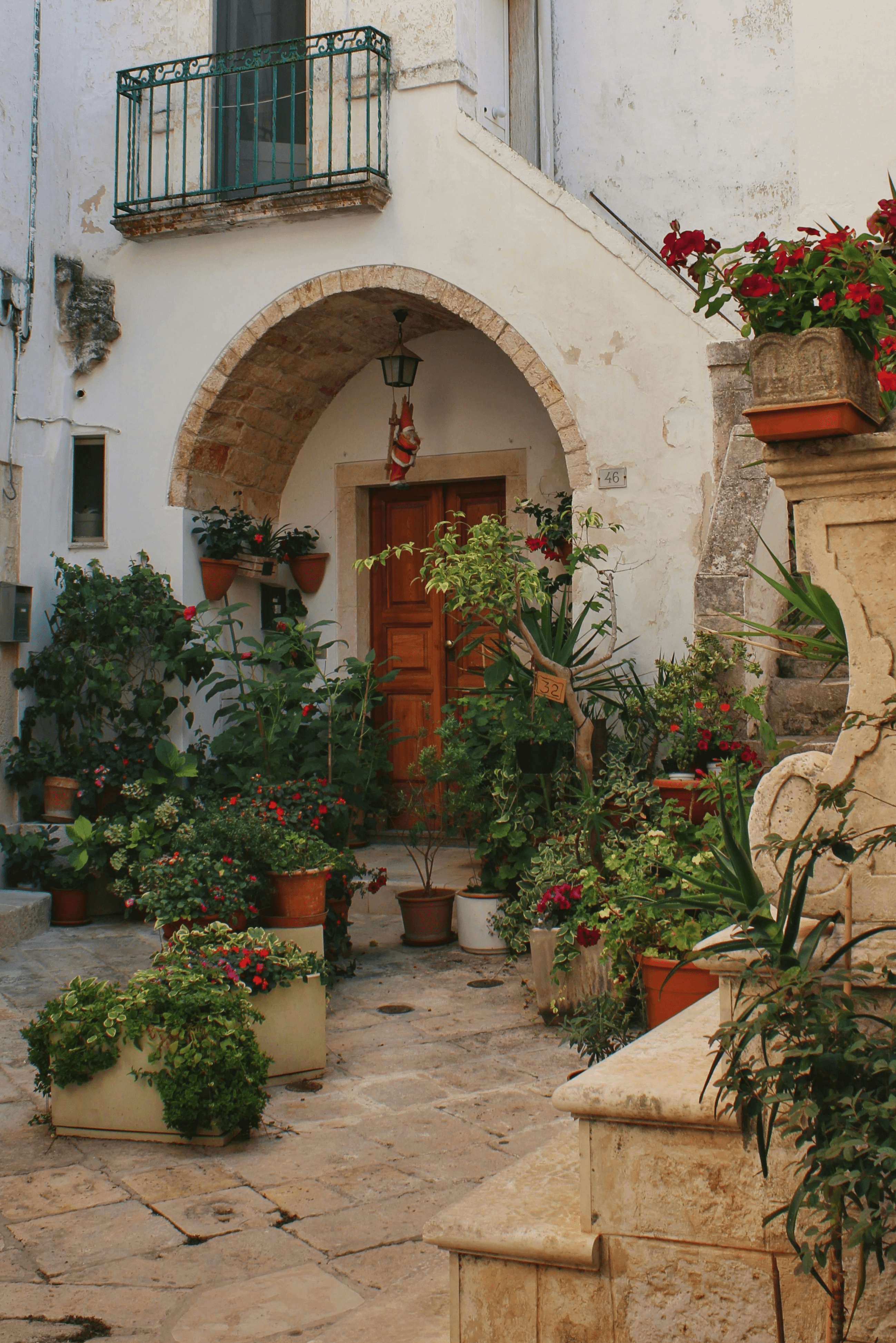 a building with a bunch of potted plants in front of it