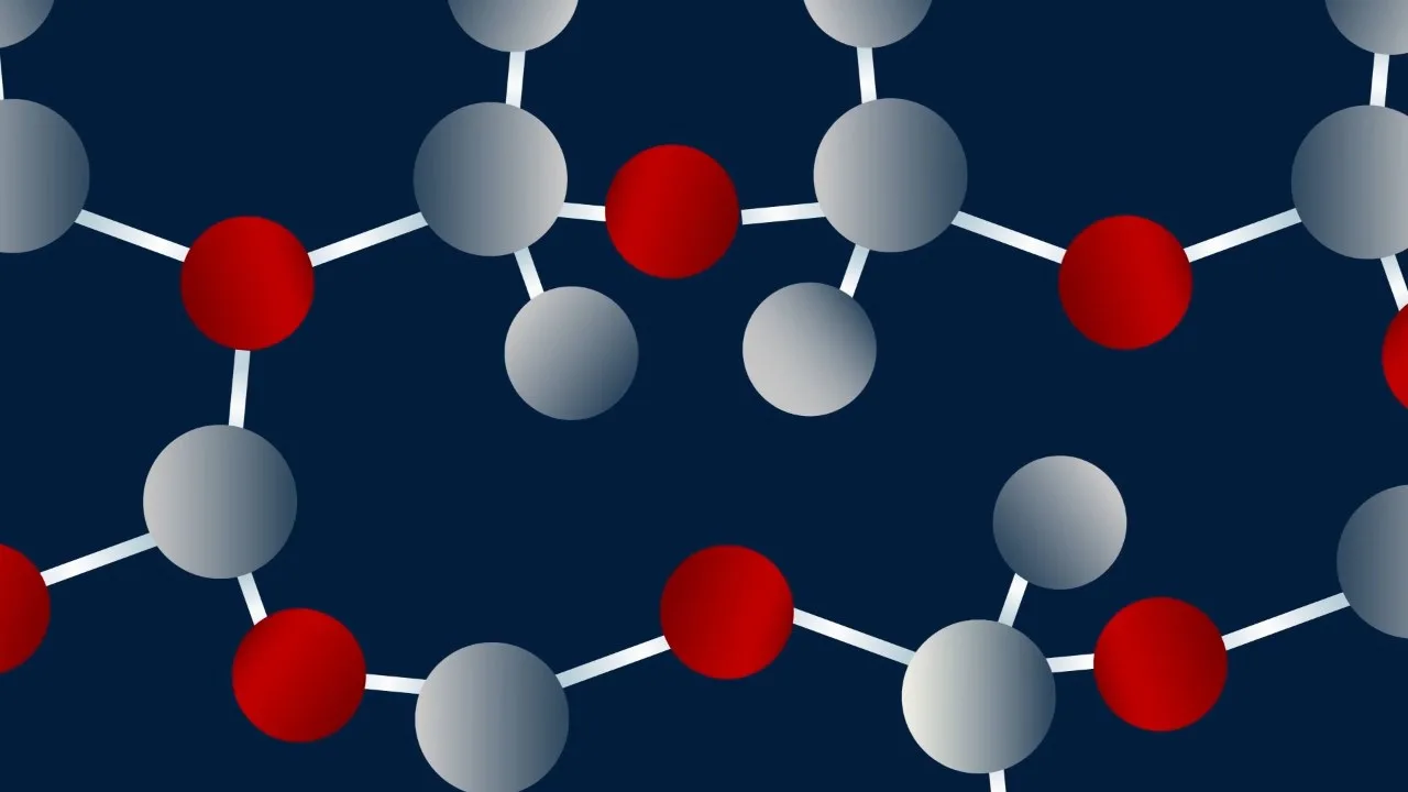 Red and white atoms linked in a chain, breaking apart on a dark blue ground