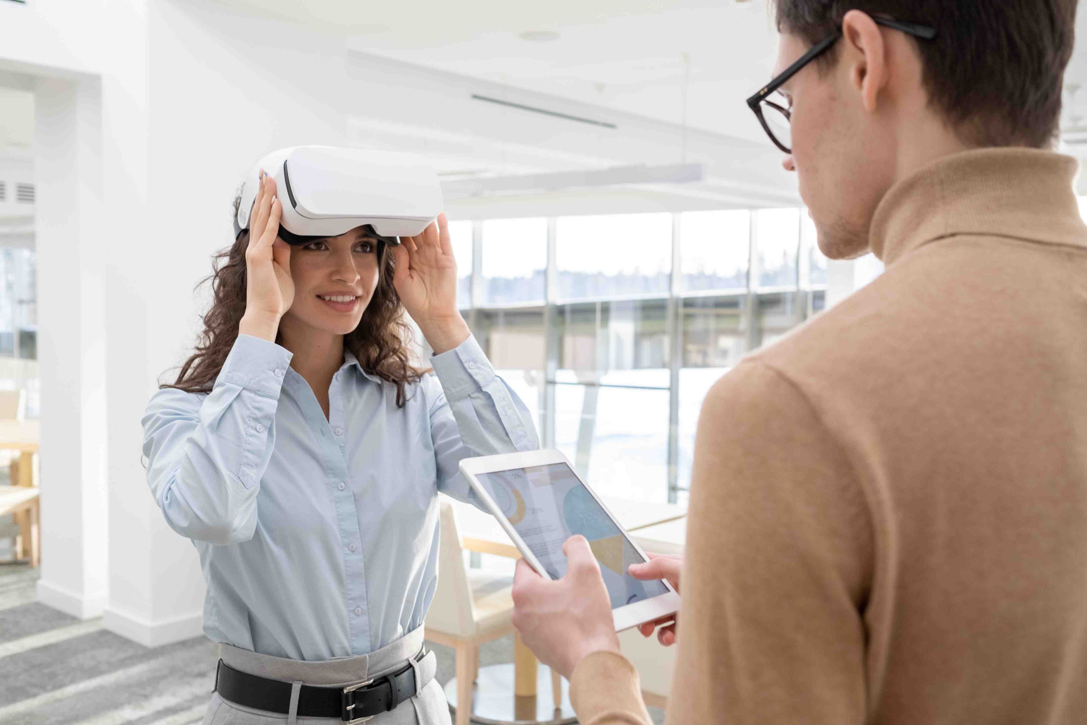 Businesswoman exploring interactive walkthroughs with a VR headset during a digital presentation