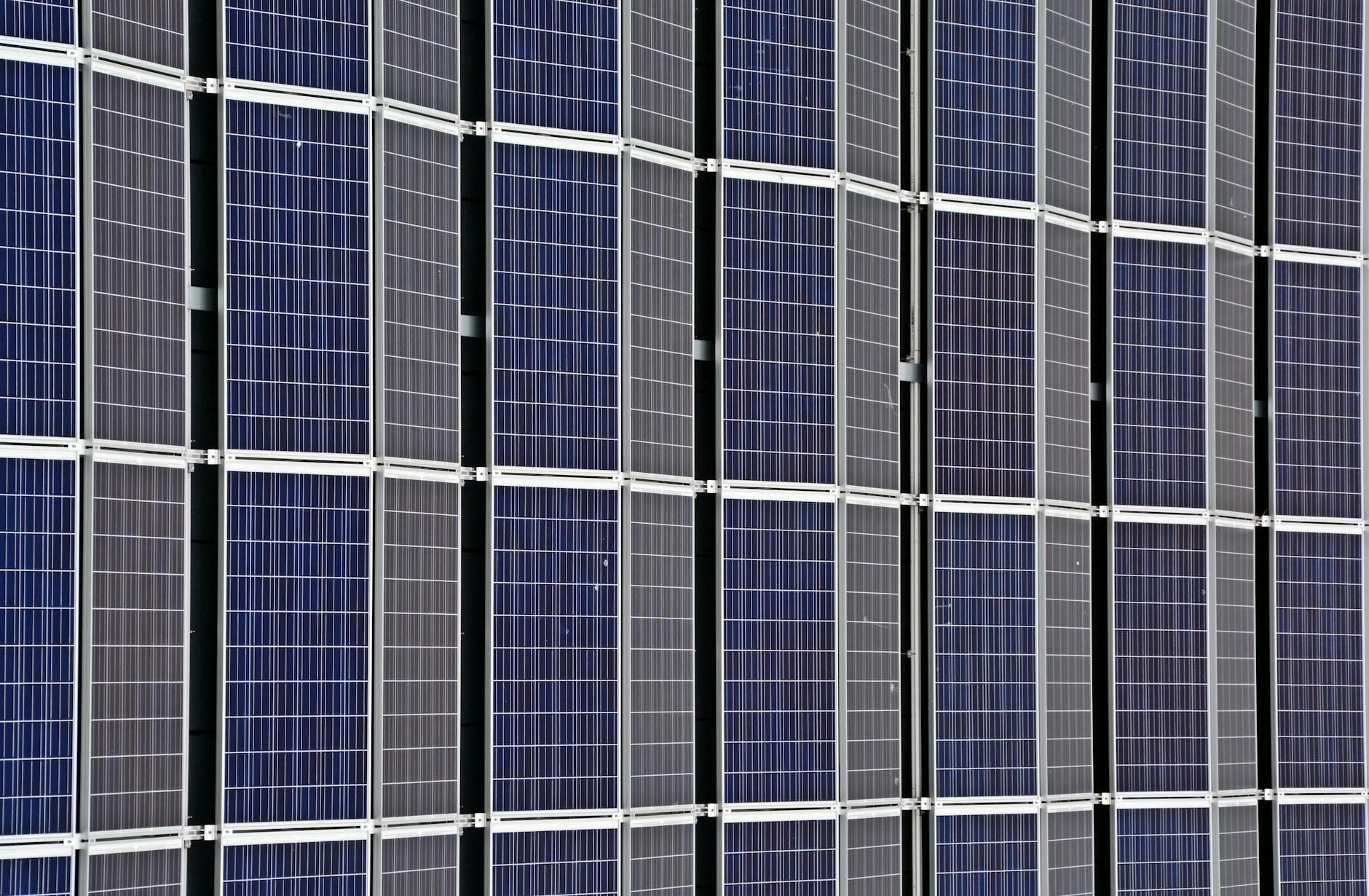 Close-up view of blue photovoltaic solar panels arranged in a grid pattern