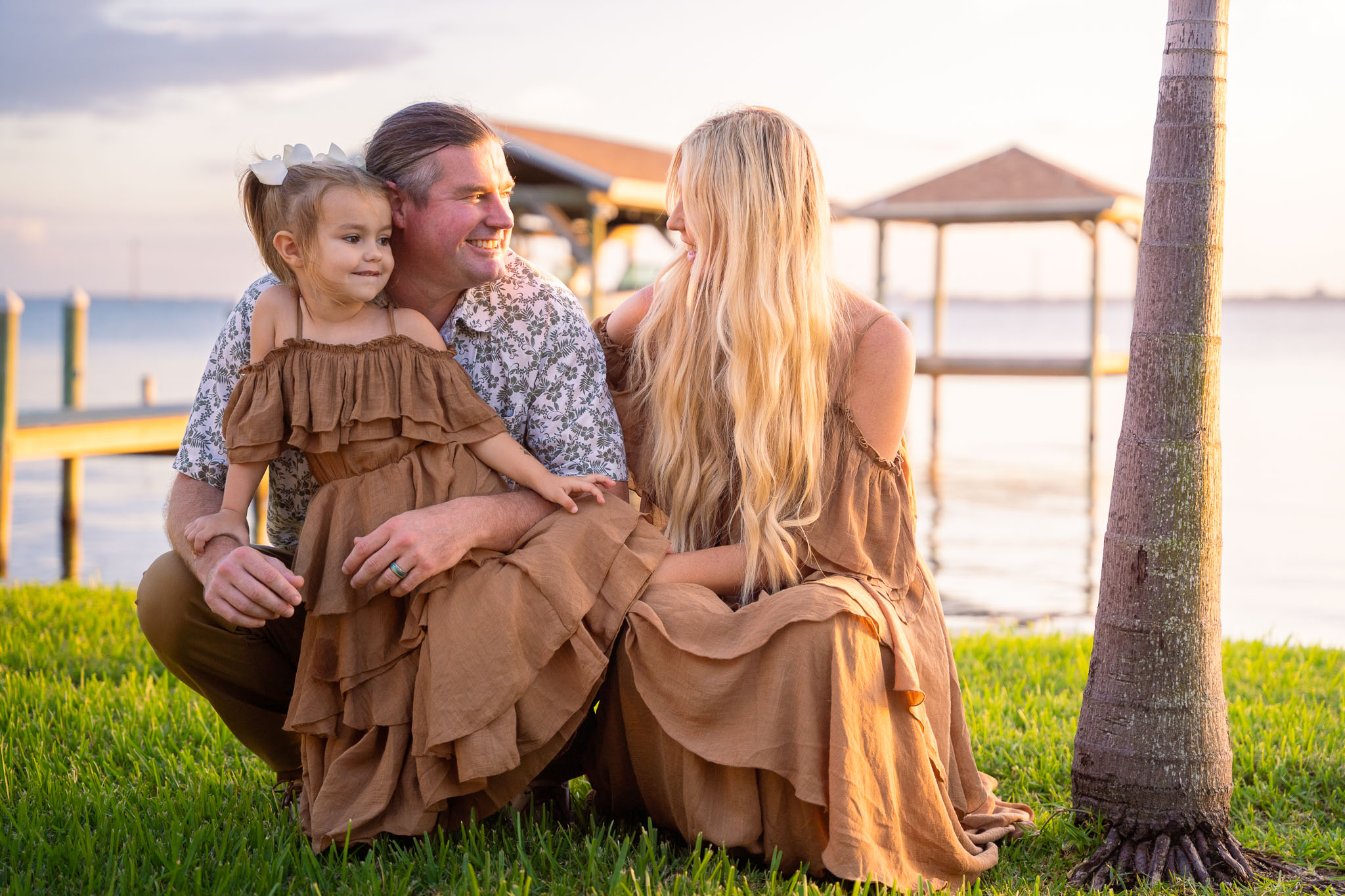  family in front of a river scene, smiling at each other