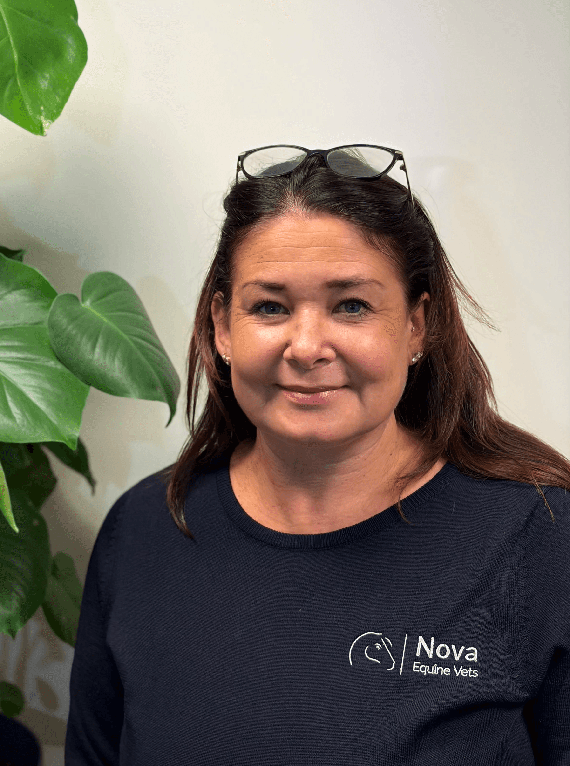 a man in a blue shirt smiling at the camera