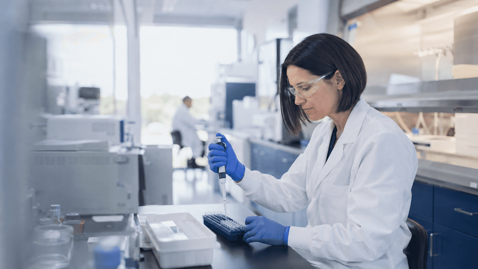 A scientist conducts pharmaceutical research at a laboratory bench.