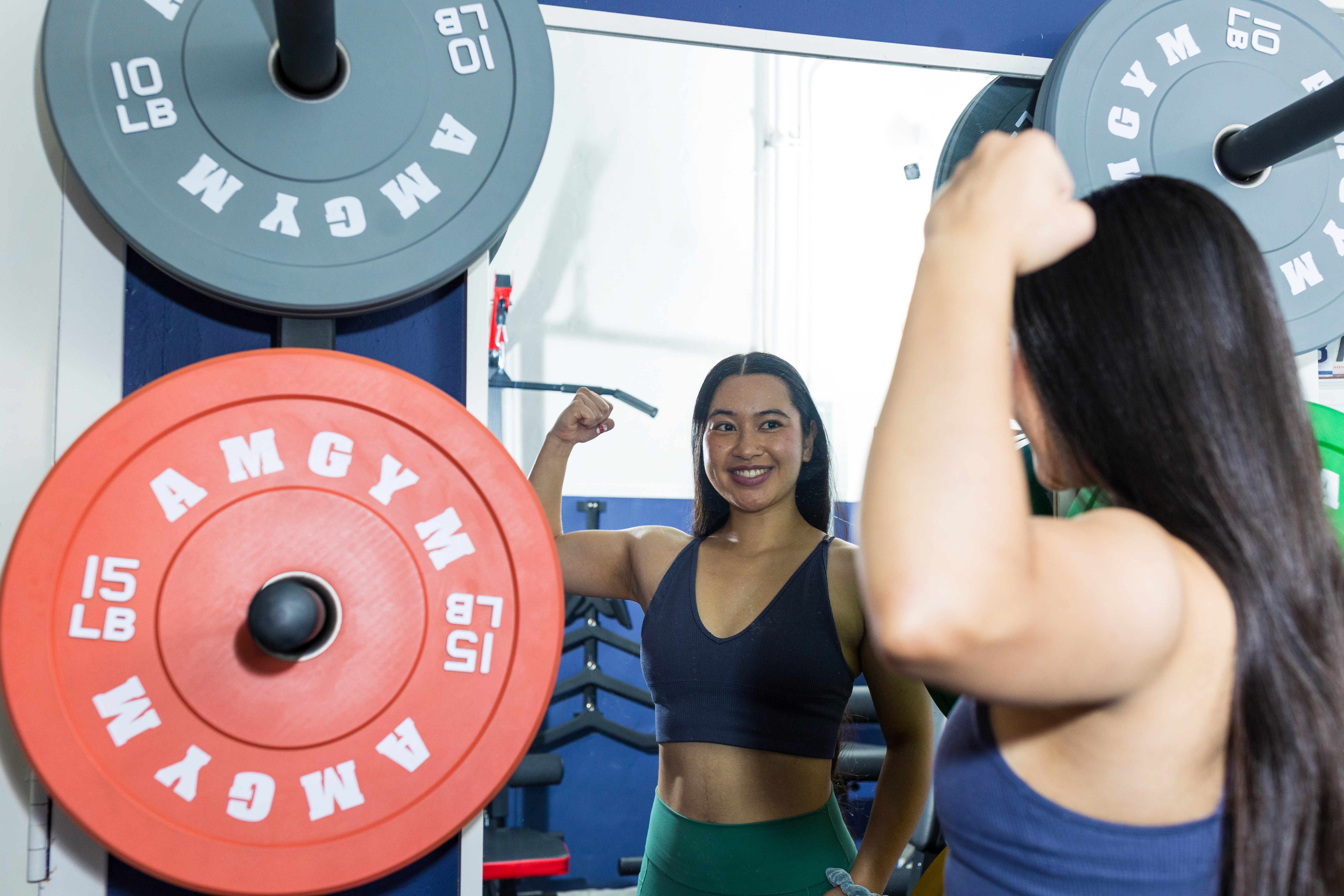 Badass, strong woman in her 80's lifting a heavy medicine ball while doing a lifted leg crunch