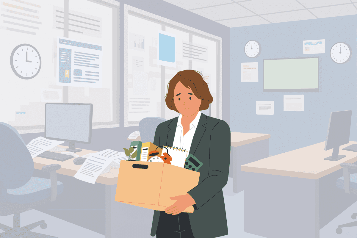 A flat illustration of a woman with a sad expression standing in a quiet office, holding a cardboard box filled with desk items like a calculator, a clock, and a notebook. She appears to be leaving her job, with empty desks and computer monitors visible in the background.