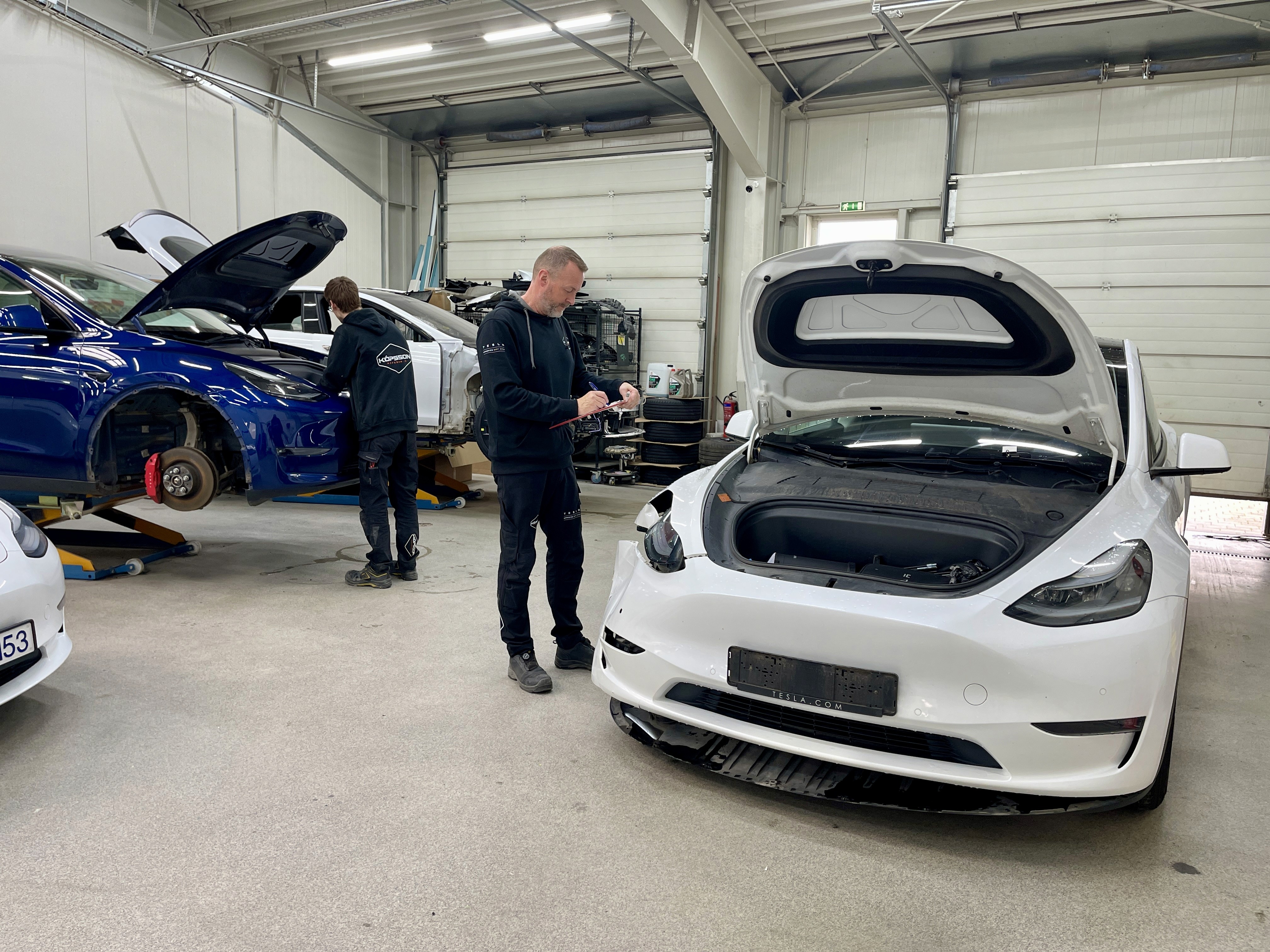 a man working on a car in a garage