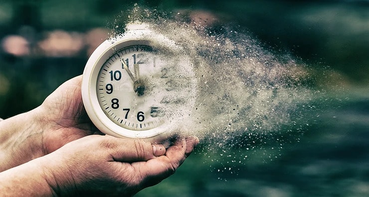 woman holding a clock with it fading away