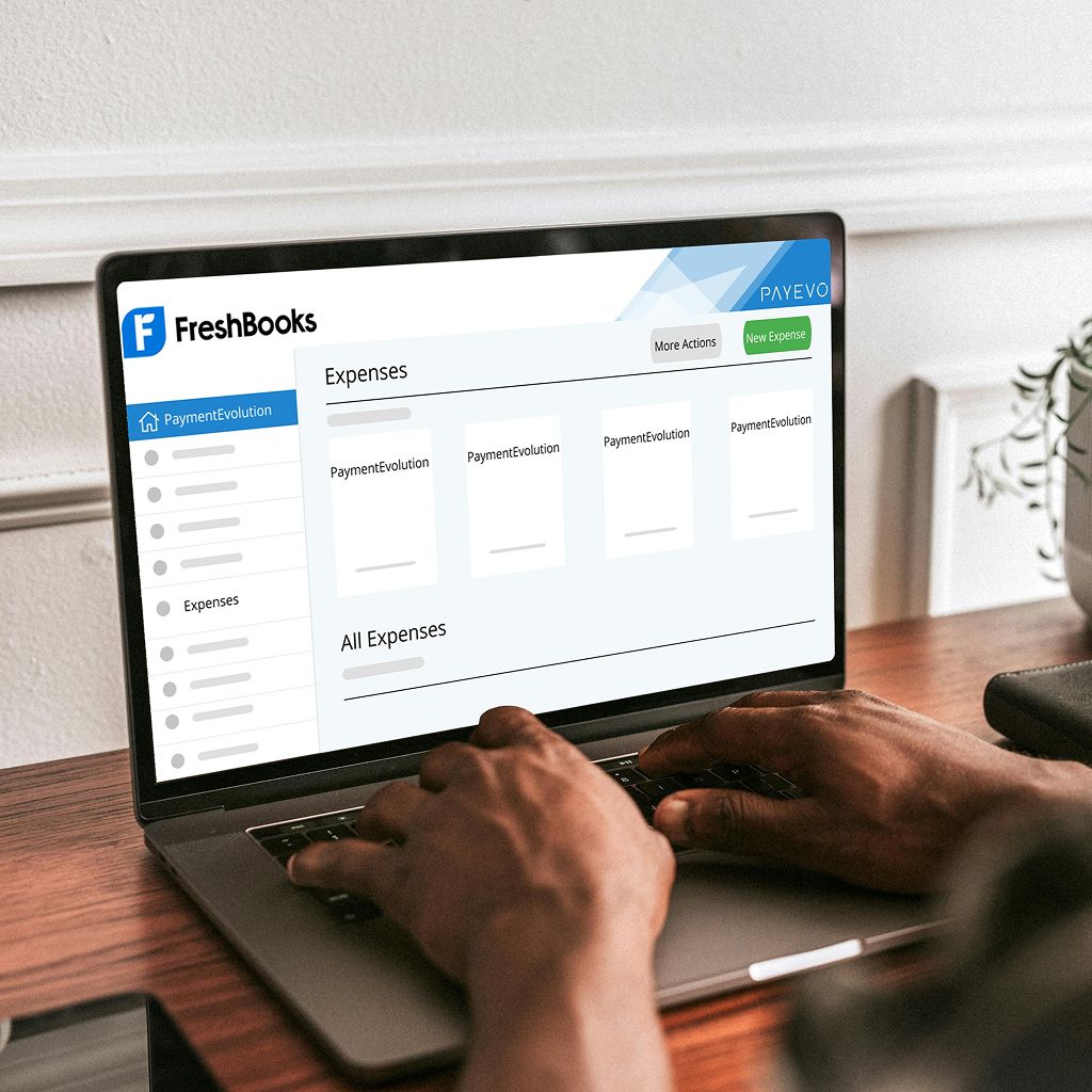 Laptop displaying FreshBooks expenses dashboard with PaymentEvolution integration showing expense entries