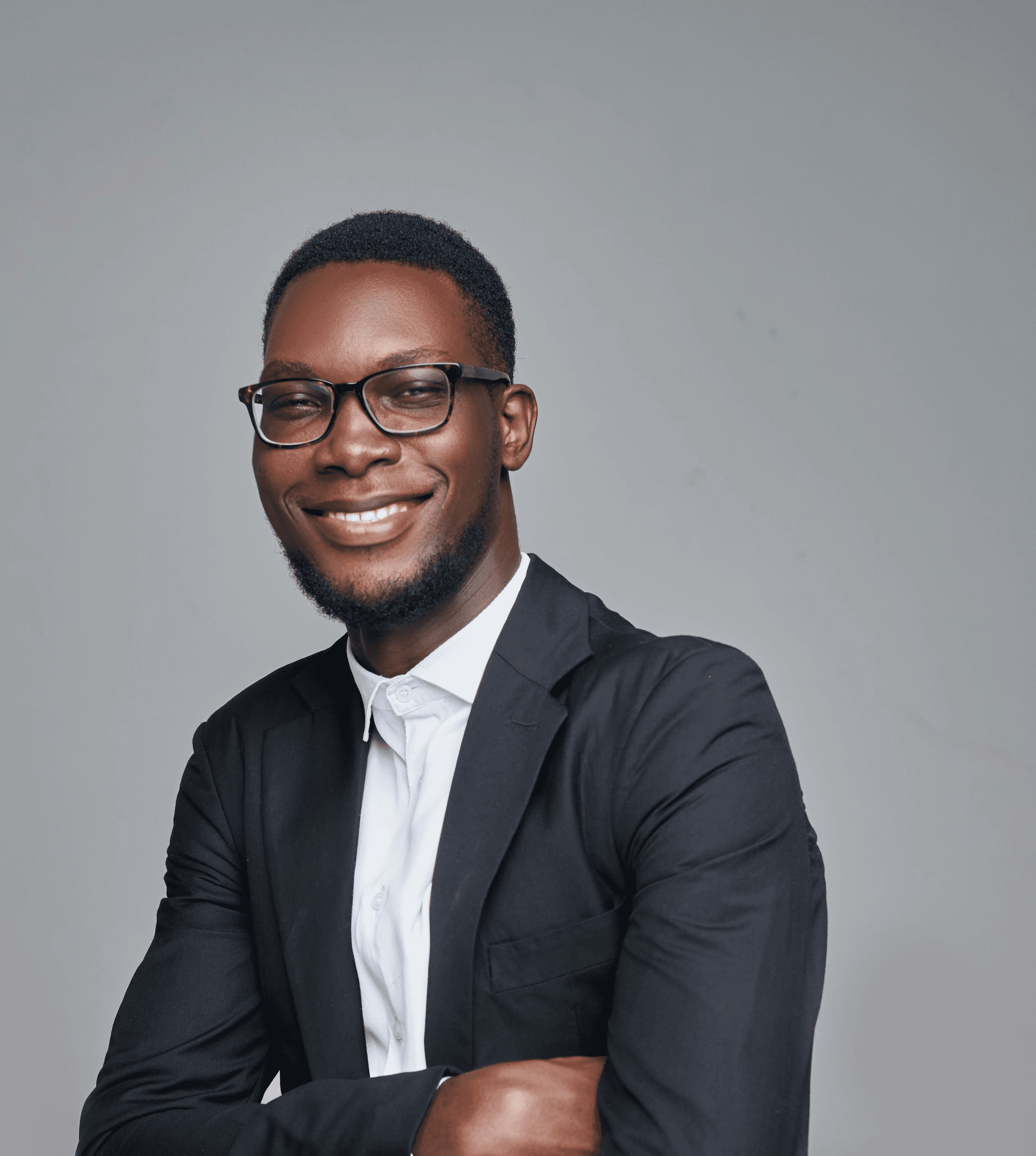 a man in a suit and glasses posing for a picture