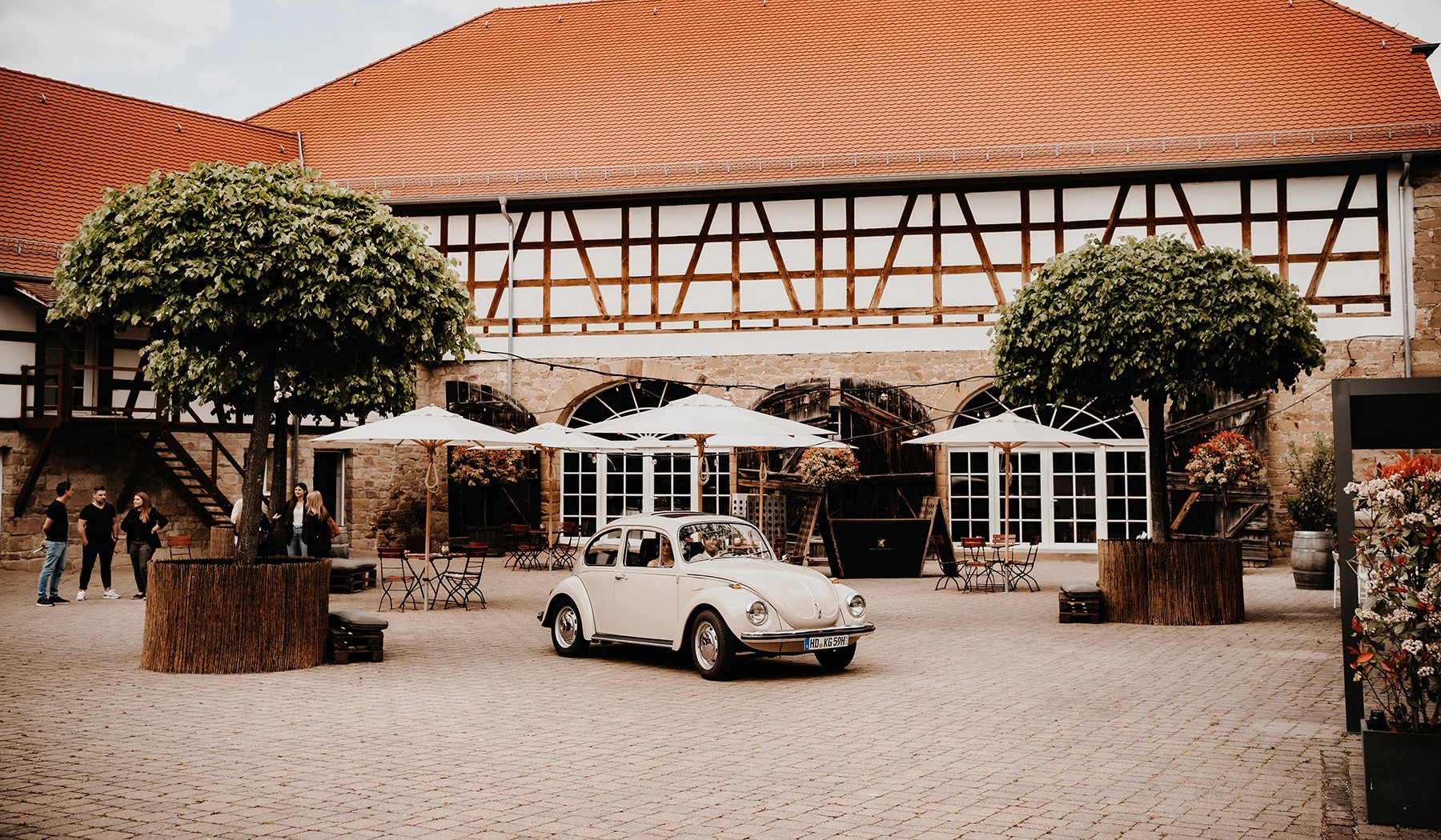 Person balancing on rocks by the ocean at sunset