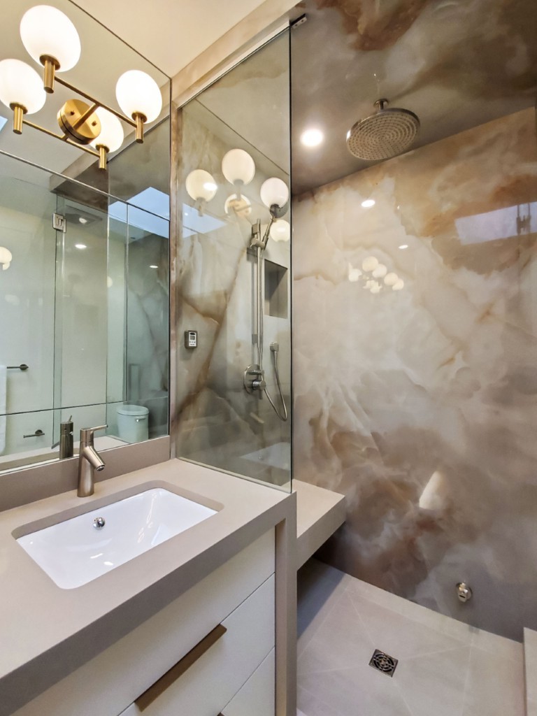 Image of Luxurious primary ensuites with marble wall design and modern sink area by KHD Homes design-build.