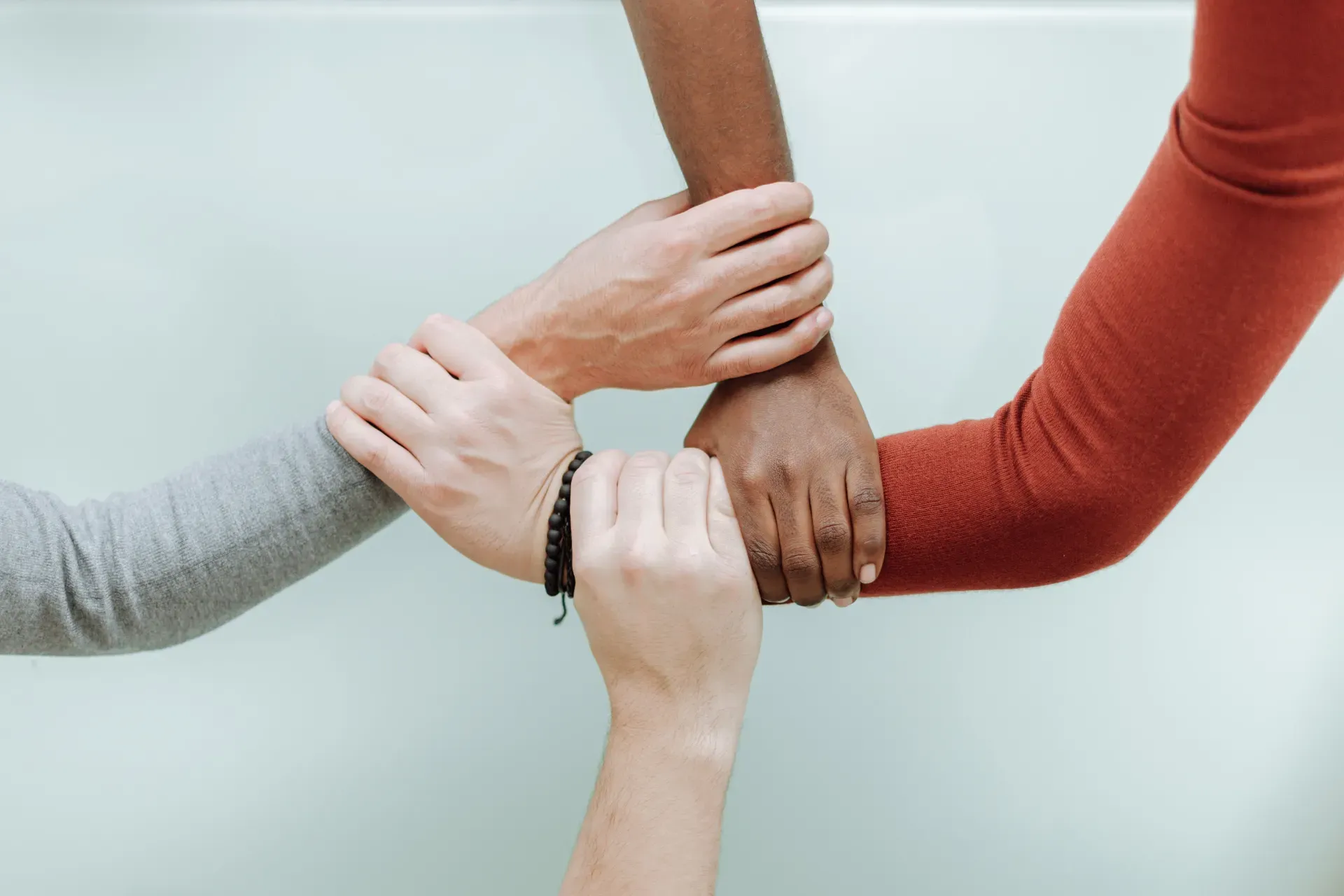 Hands of diverse people connecting with each other