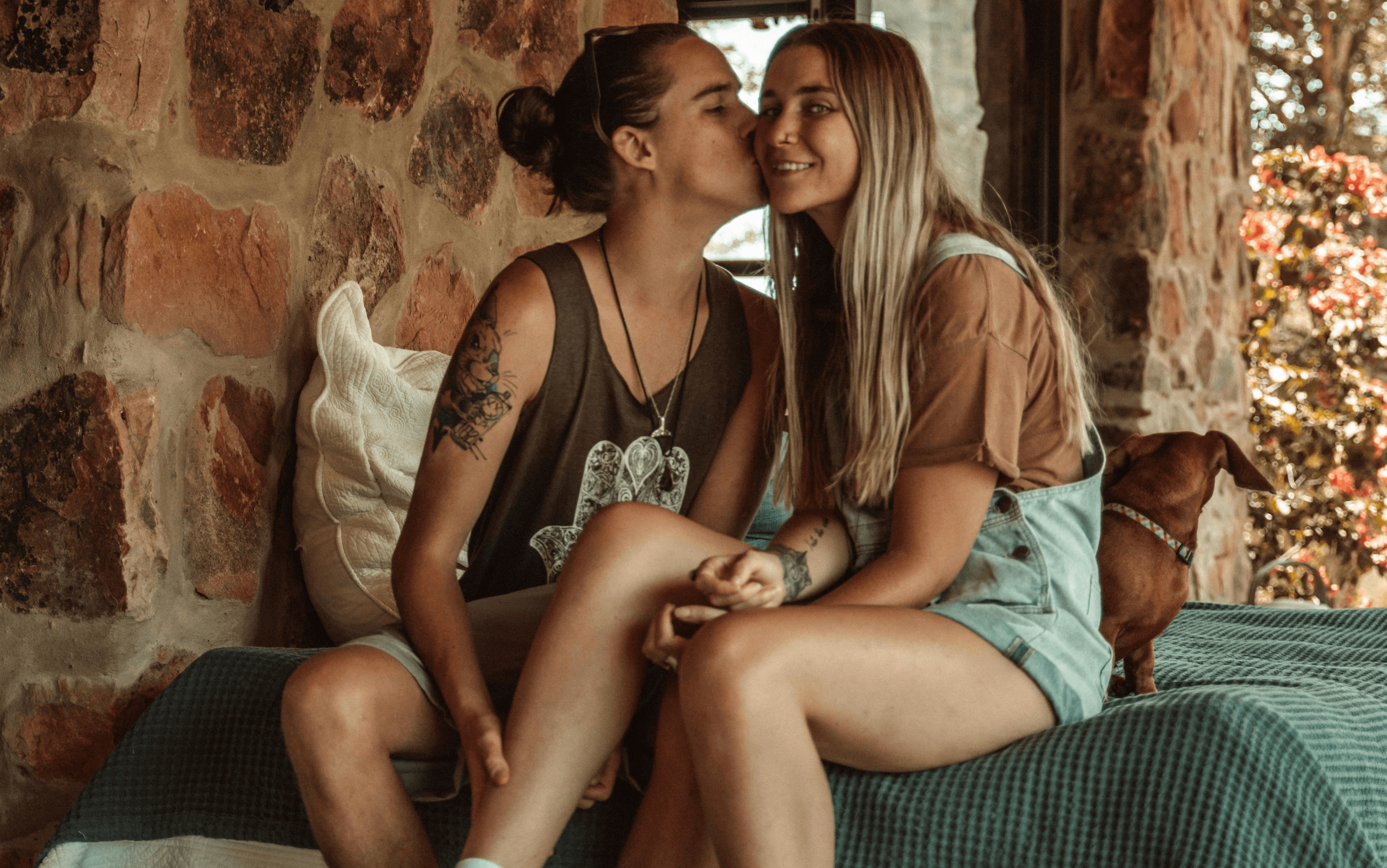 picture of a woman kissing another woman on the cheek