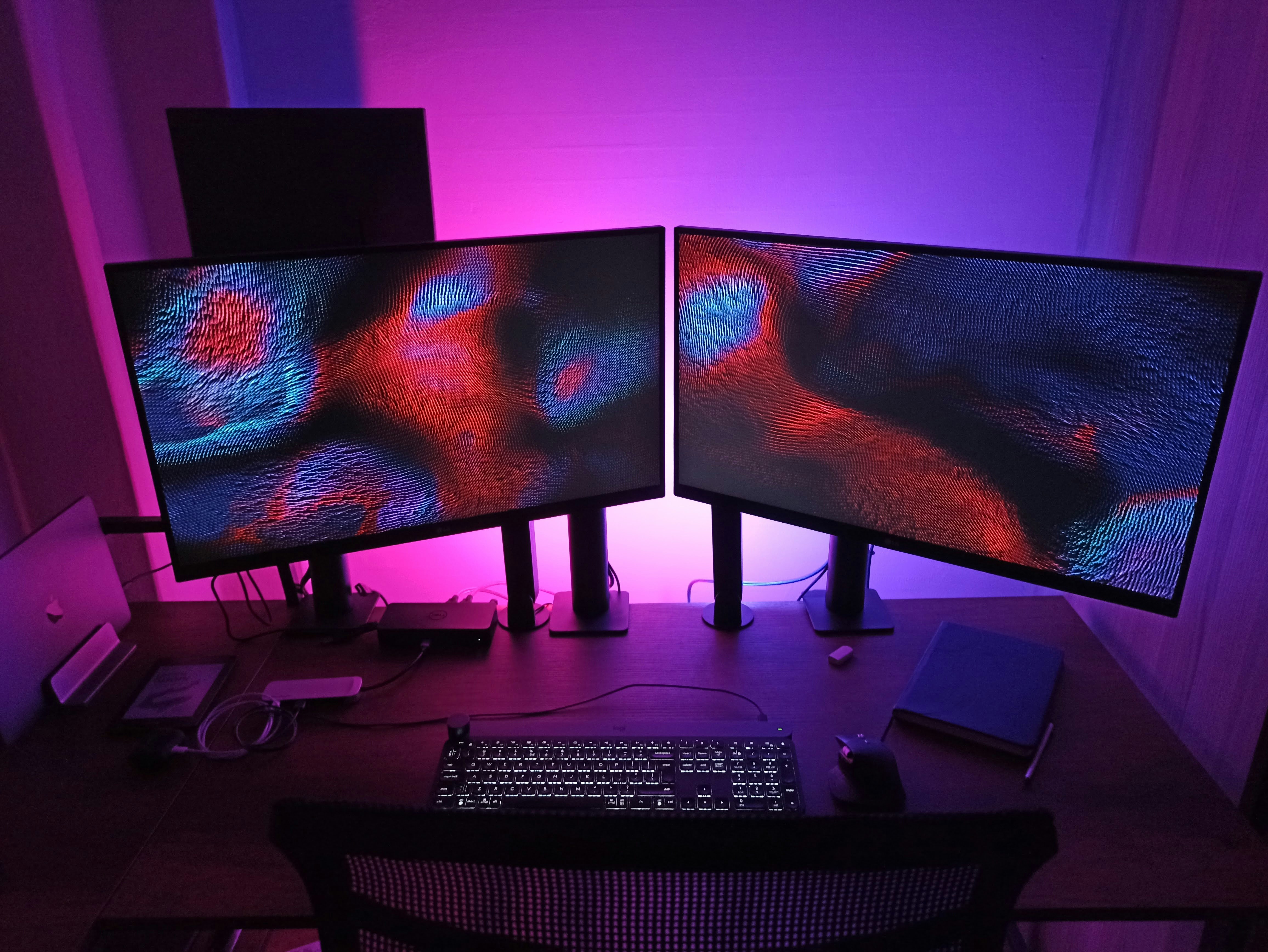 dual monitors and black computer keyboard on black table