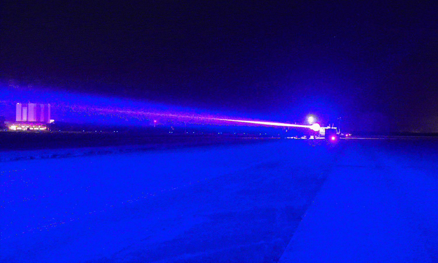 Star Catcher beams laser down Launch and Landing Facility at Kennedy Space Center with VAB in background