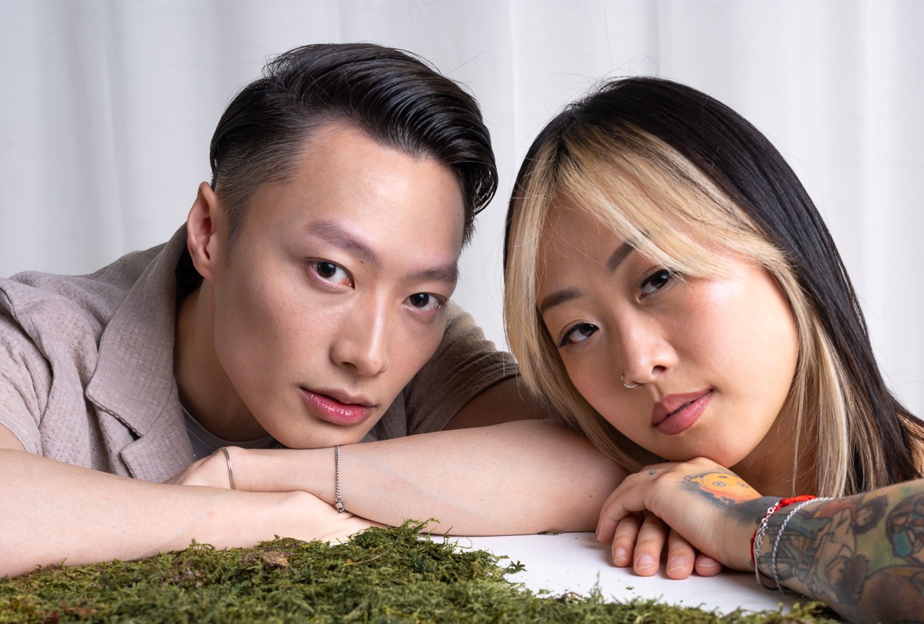 Two people resting head near moss