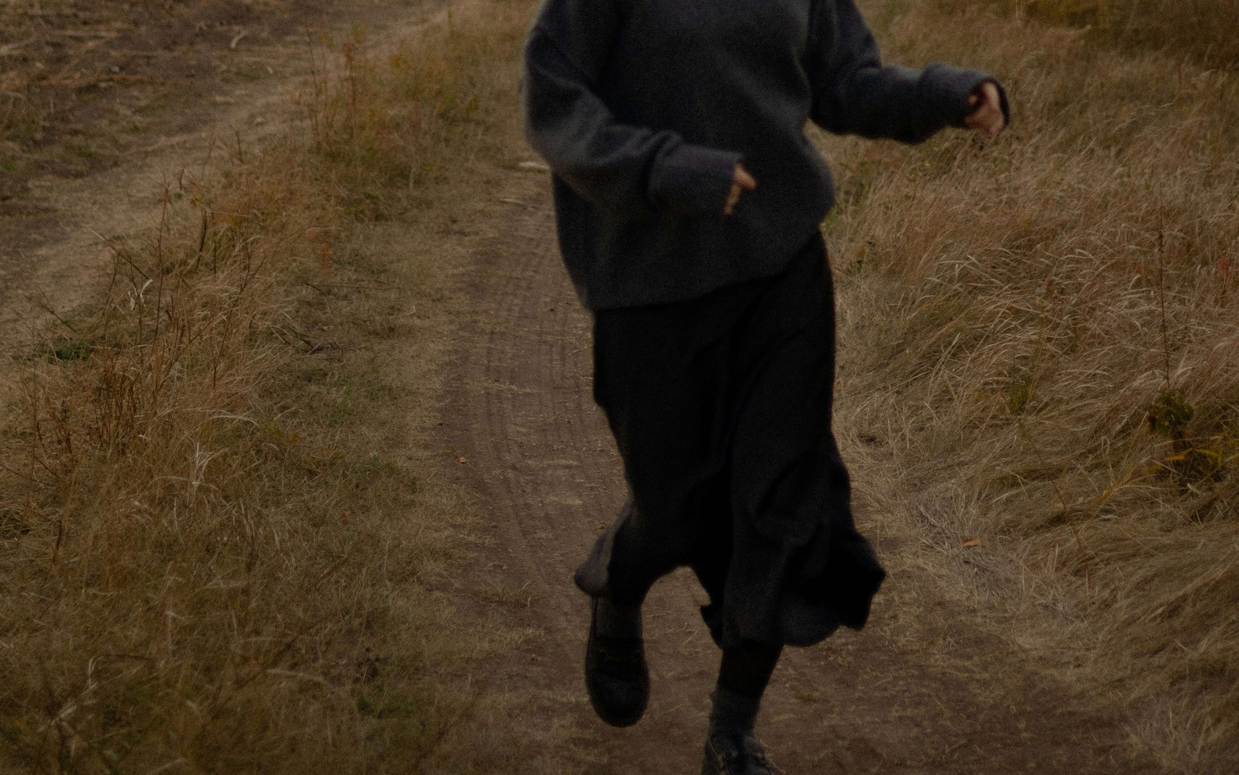 Woman running on a dirt road