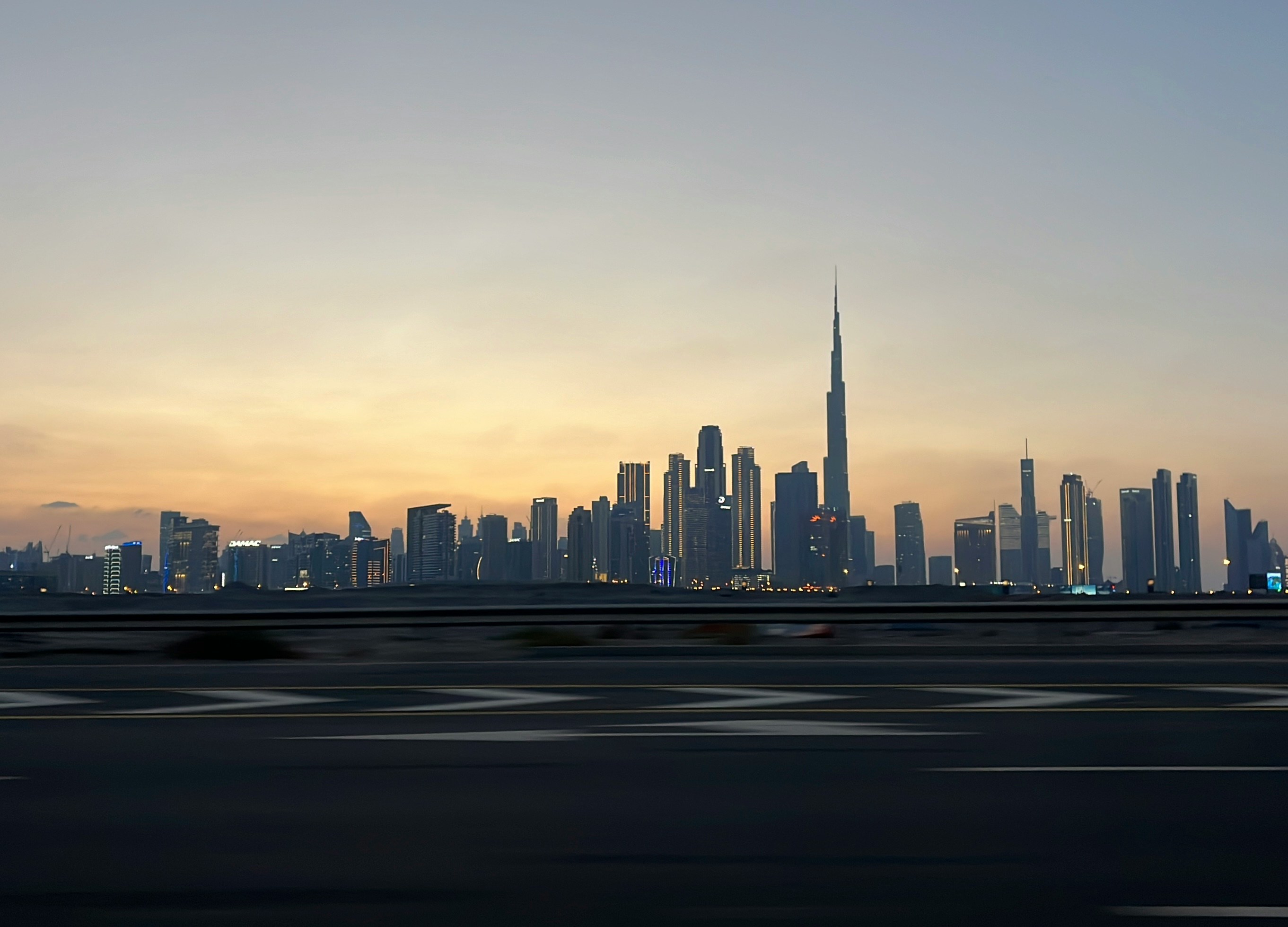 A picture of a city skyline taken from a moving car