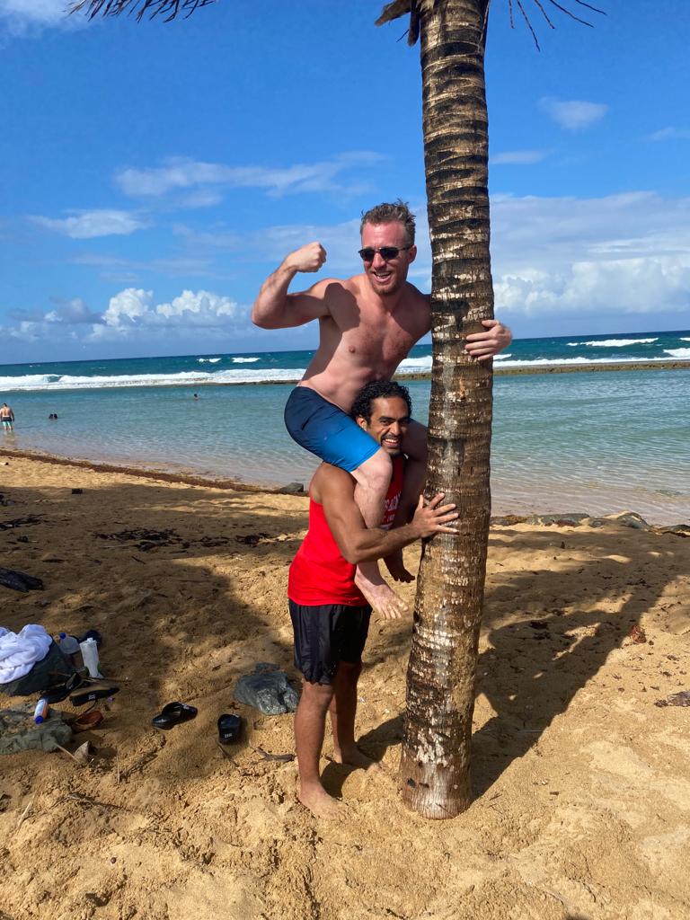 Two people posing playfully on a Puerto Rico beach during Puerto Ricans on the Rise film shoot