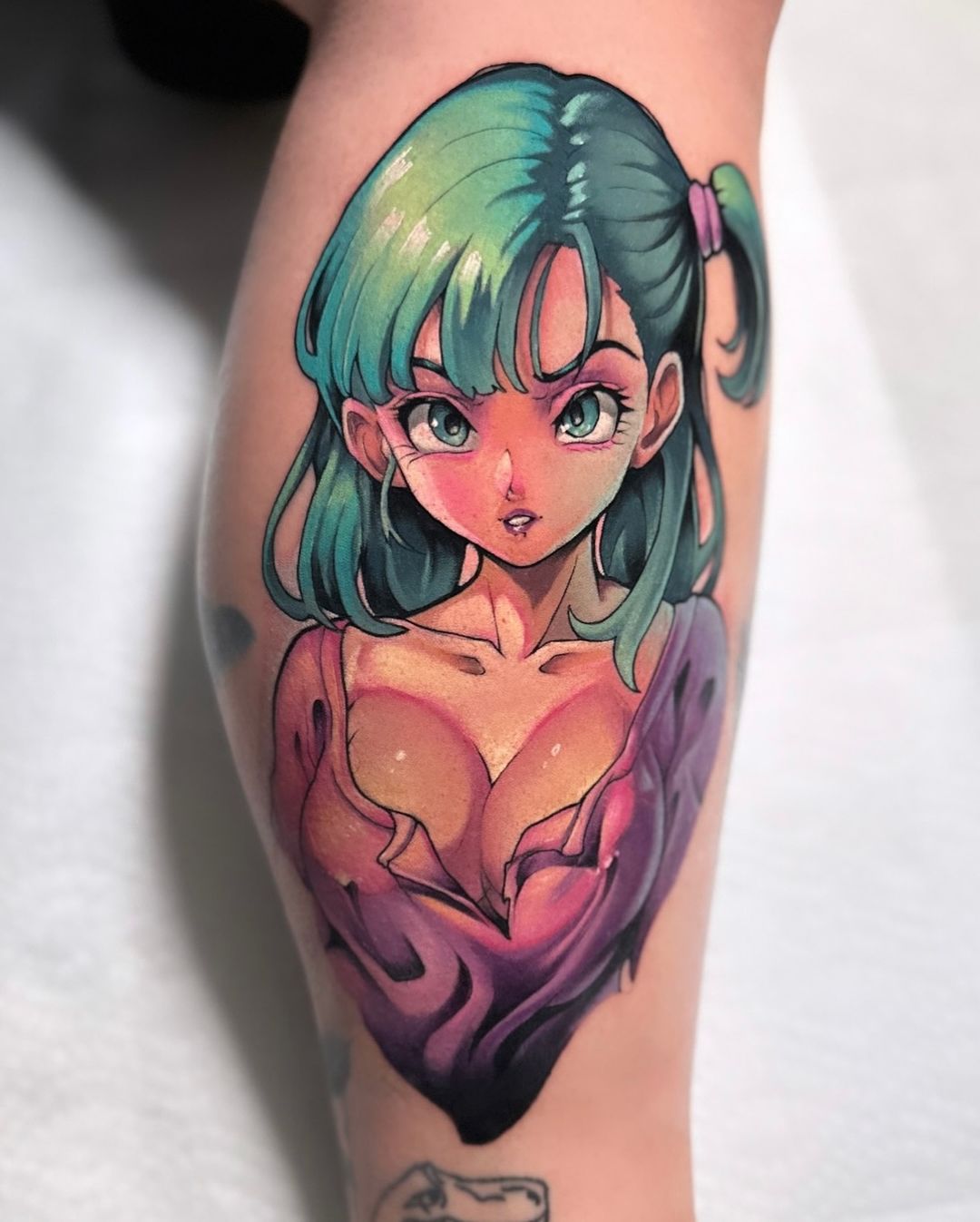 This tattoo features Bulma from Dragon Ball, showcasing her vibrant green hair and confident expression, highlighting her character's charm and strength.