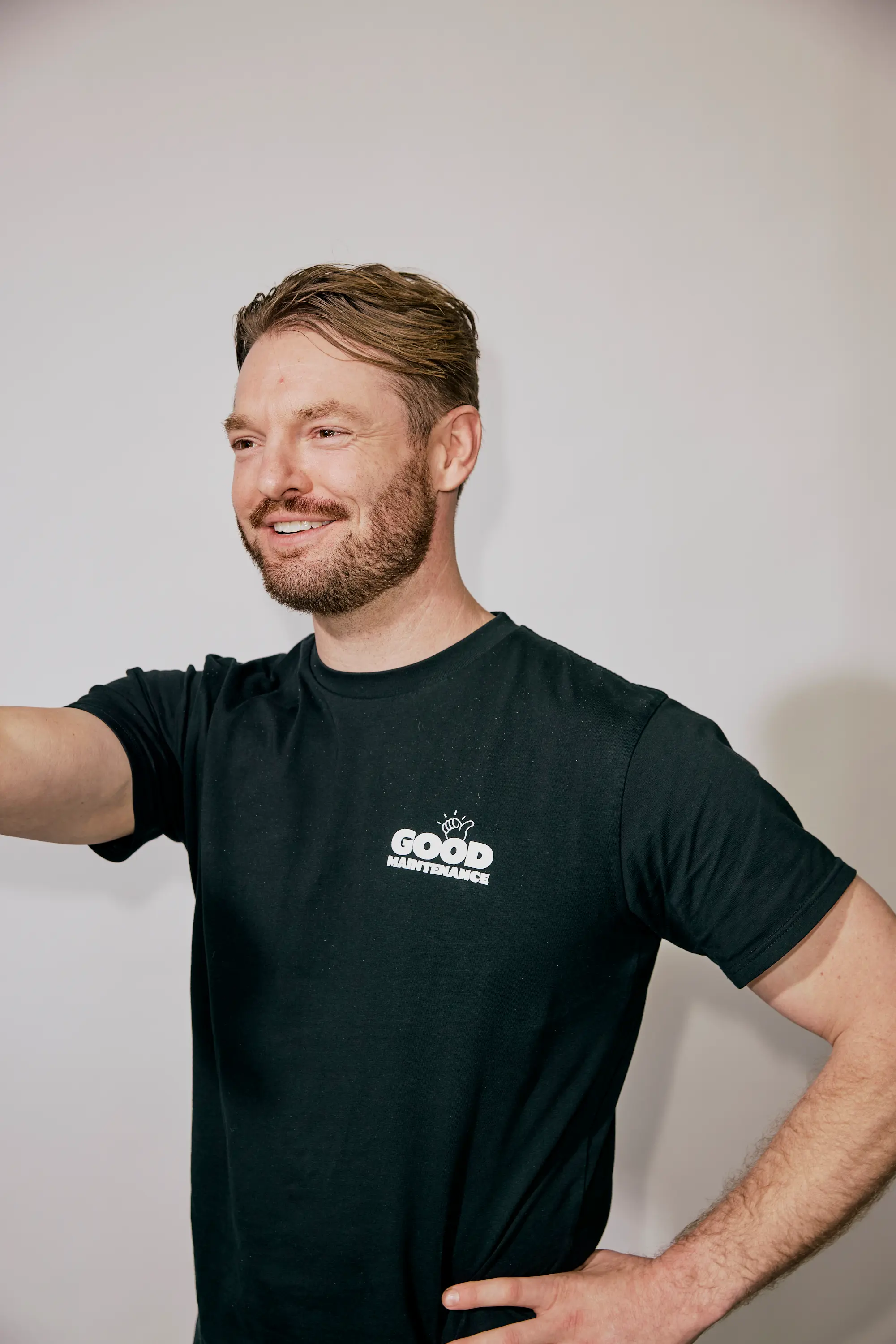 Playful portrait of a male Team Member in Good Maintenance shirt.