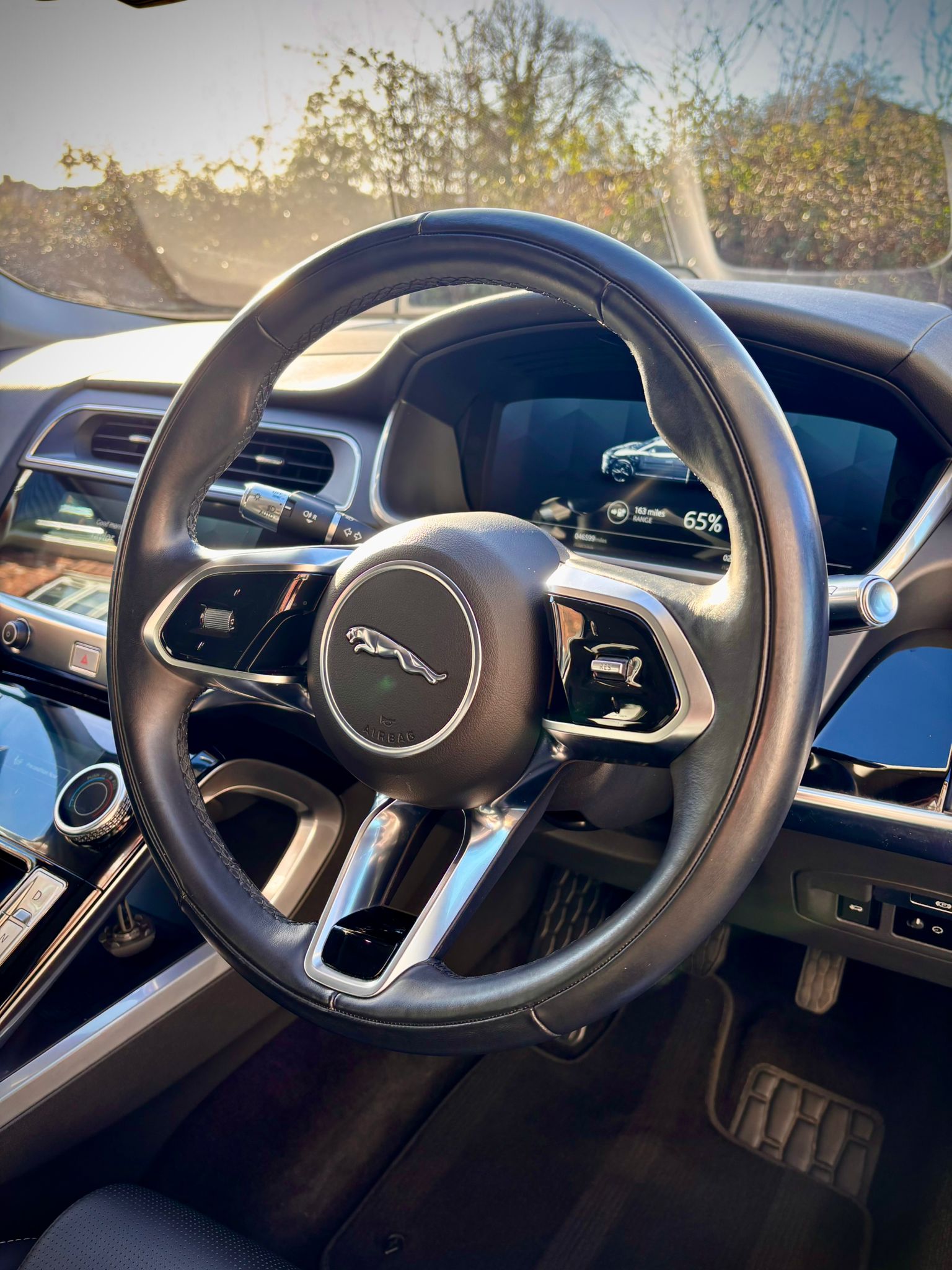 A person cleaning a car with a yellow cloth