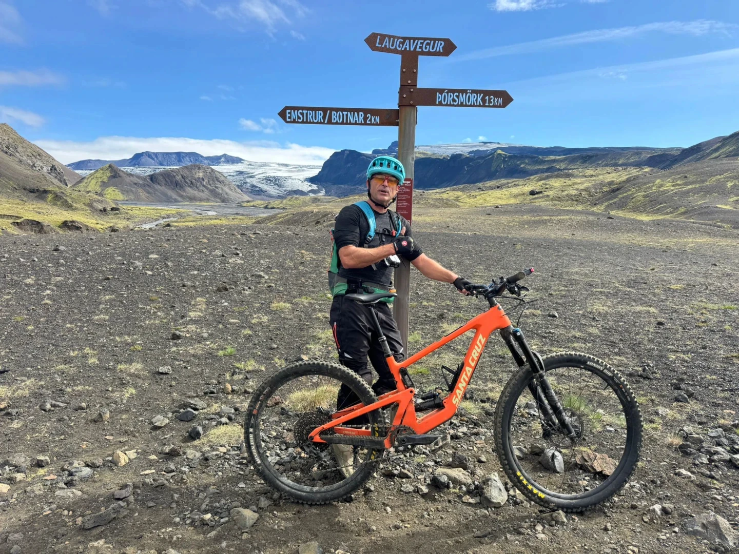 One man poses for a picture with his santa cruz bronson bike in highlands of Iceland