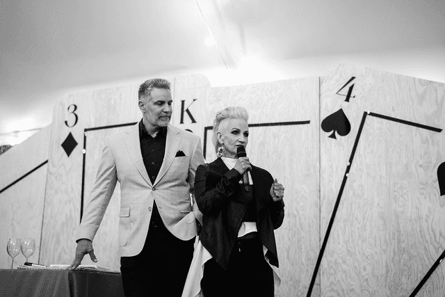 A couple in formal wedding attire embraces intimately in a vast.