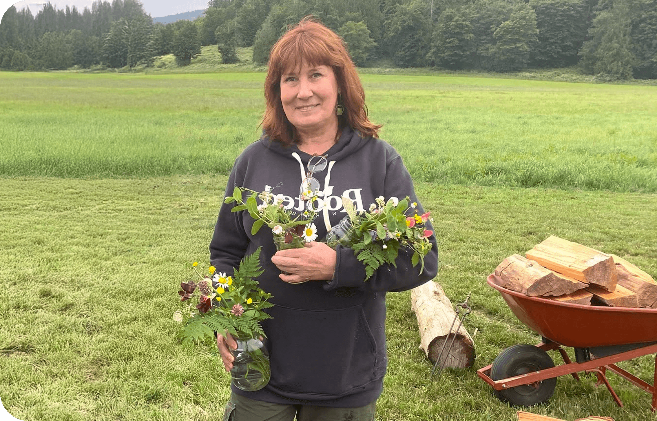 Kim holding flowers outdoors.