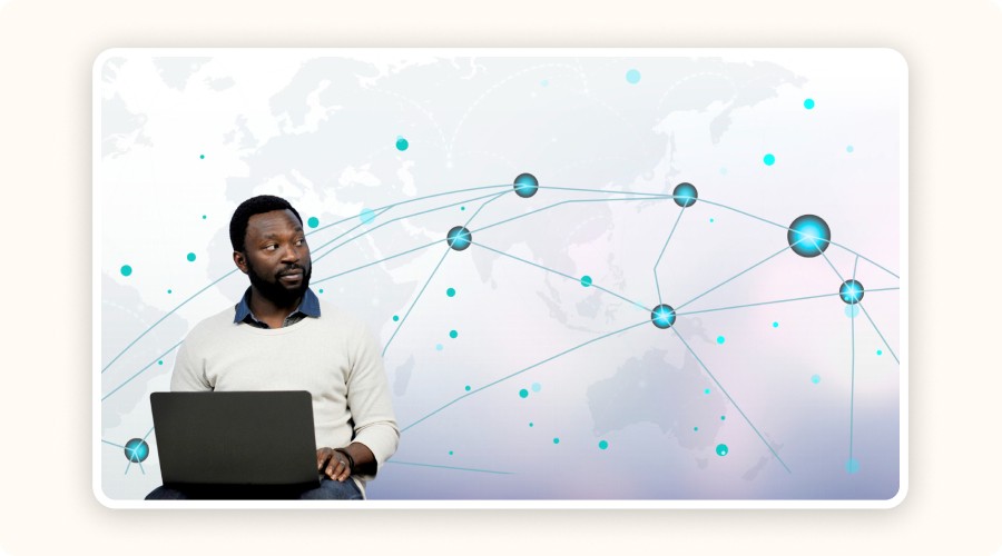Man with laptop in front of a stylized world map and digital network connections, symbolizing real-time uptime and latency tracking across global infrastructure.