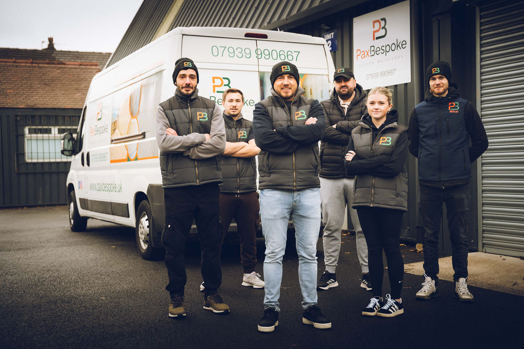 the PaxBespoke team and a work van