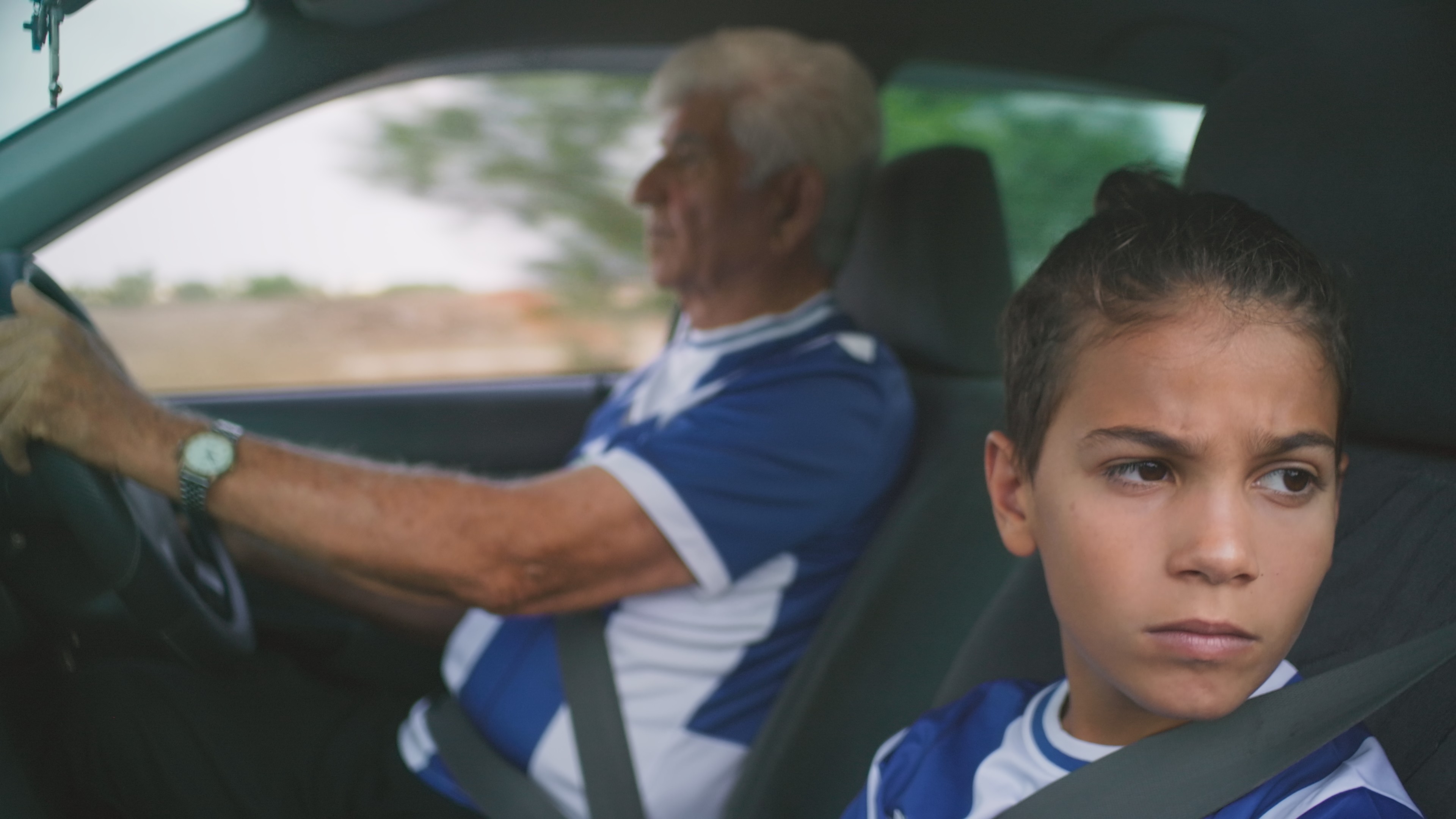 Old man is driving the car outside occupied Achna