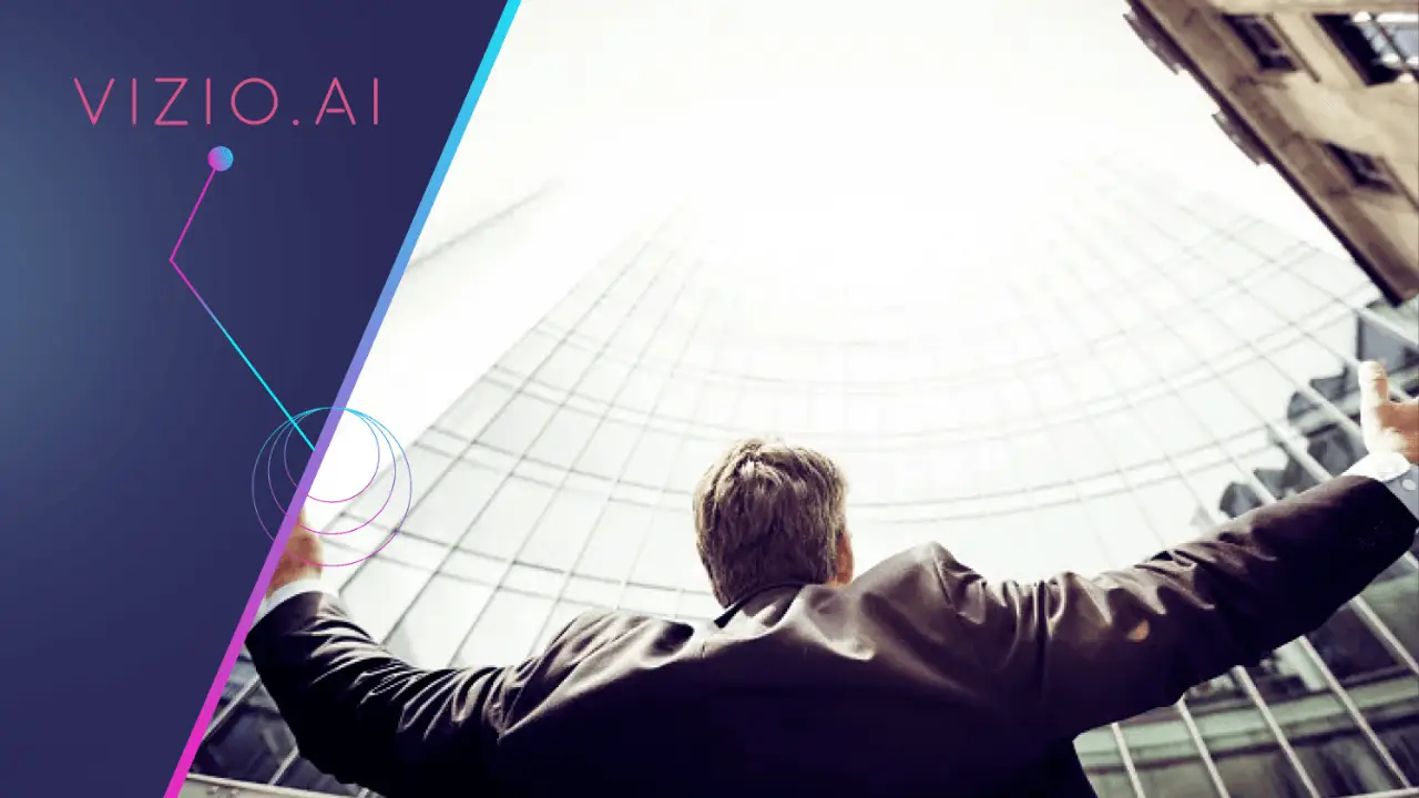 Man in a suit with arms outstretched looking up at a curved glass building.
