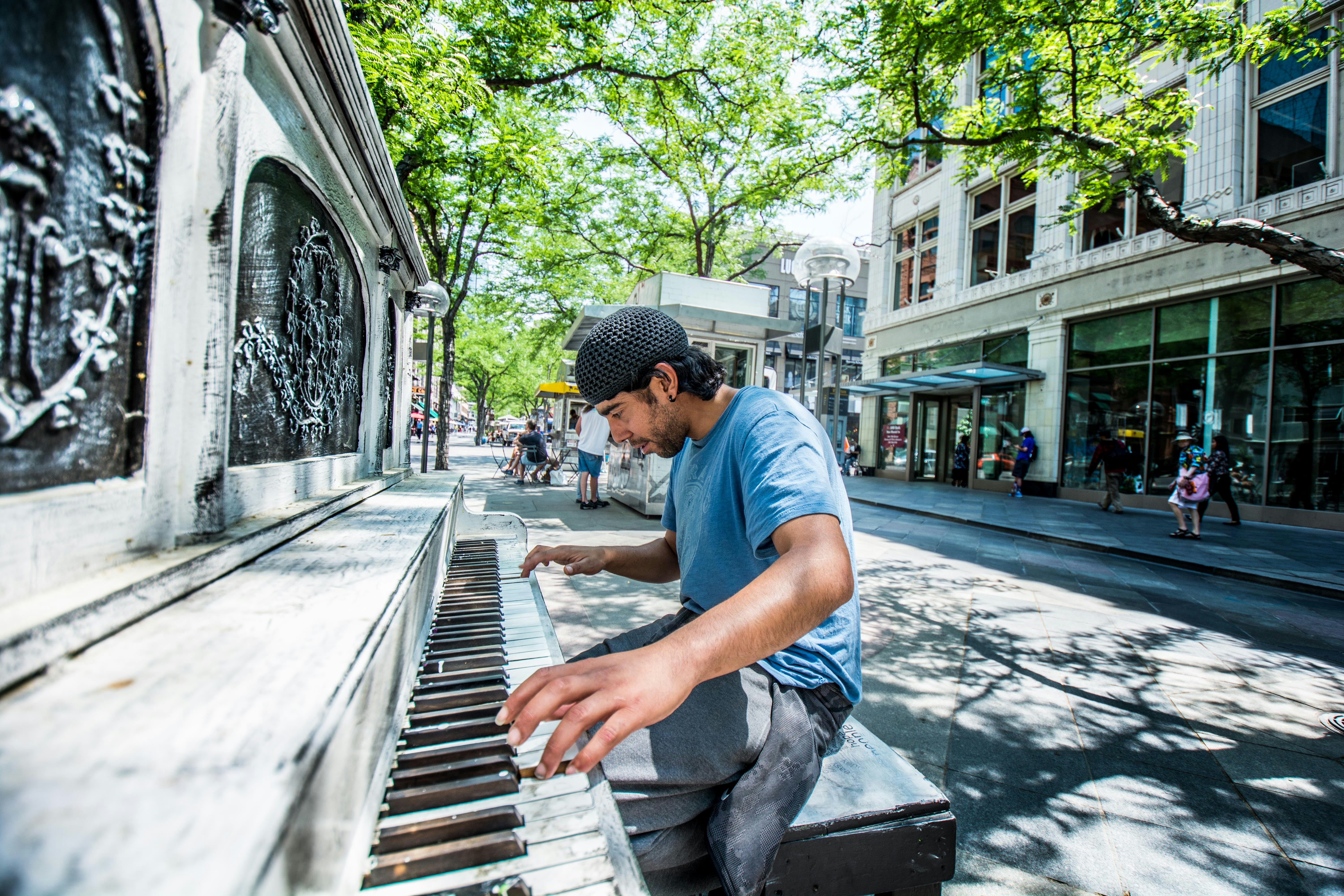 guy playing piano in public