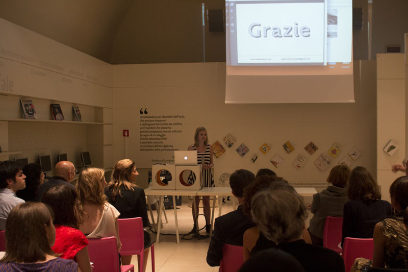 woman with a strip dress giving a presentation