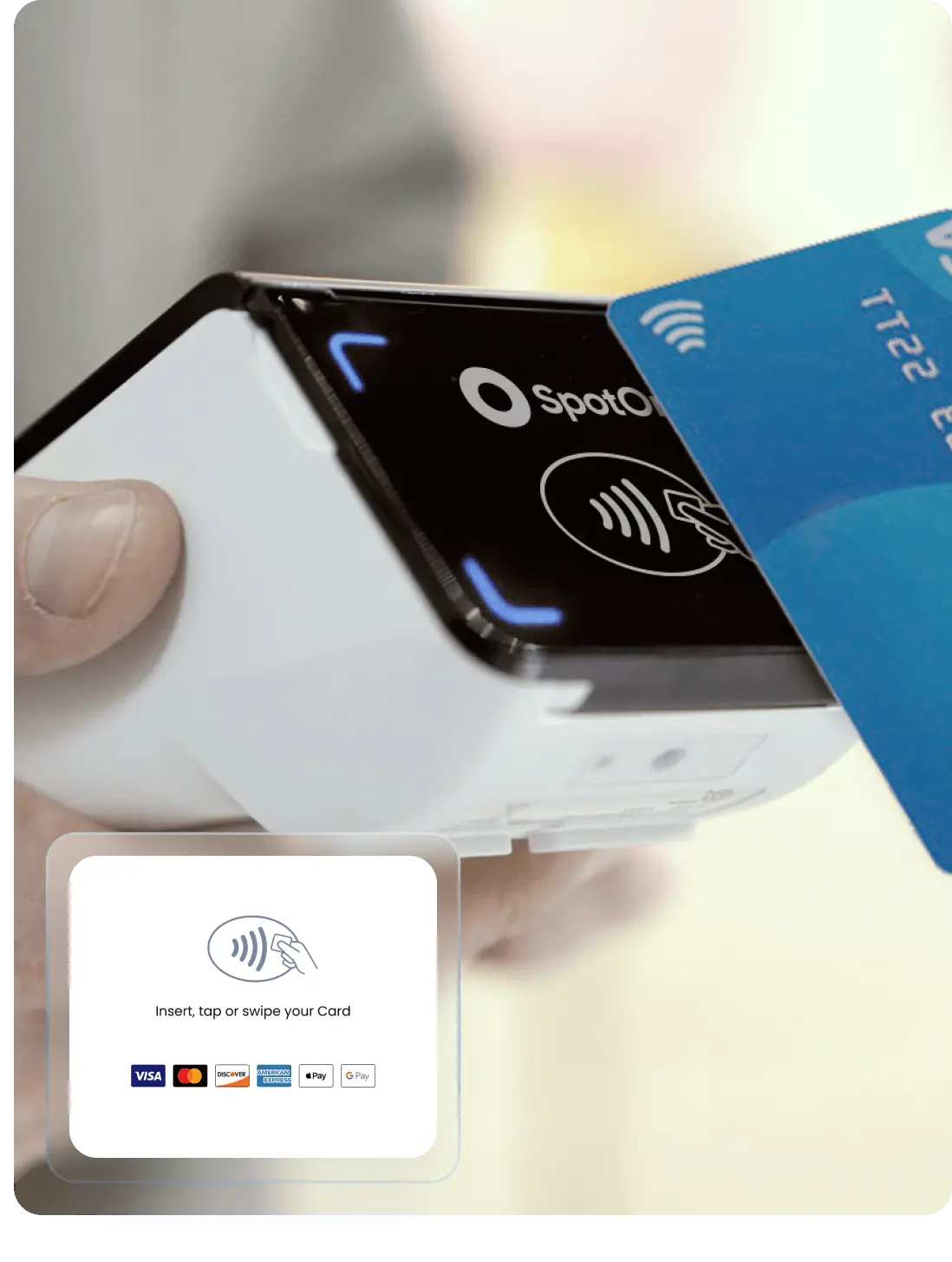 A person holds a wireless card reader while a contactless payment card is being swiped over it, indicating a modern, cashless transaction.