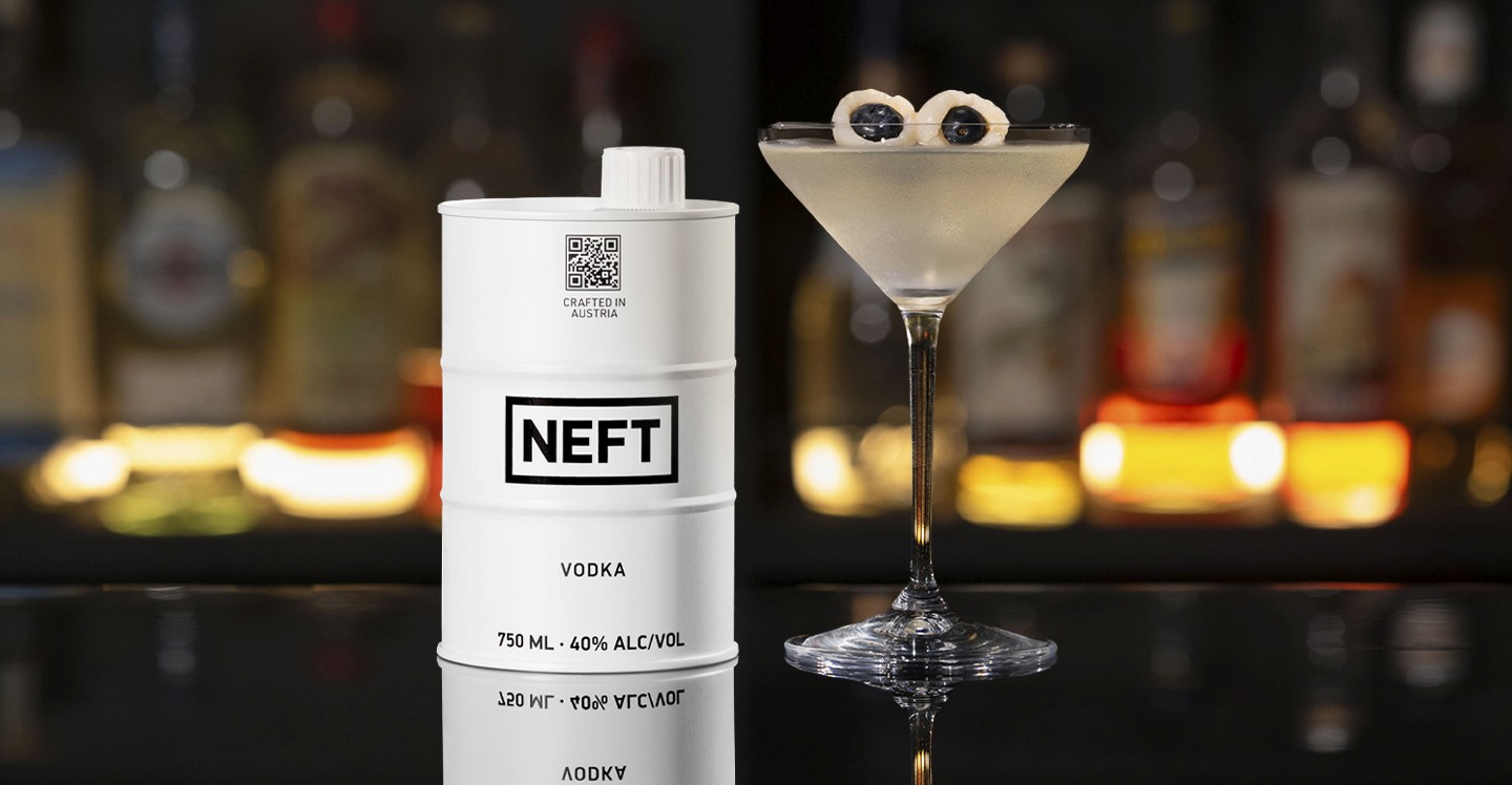 A NEFT Barrel and a glass of Saketini on a bar counter.