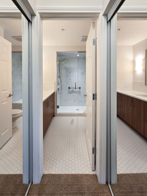 Image of Luxury primary ensuite bathroom interior with marble shower and modern fixtures by KHD Homes design-build team.