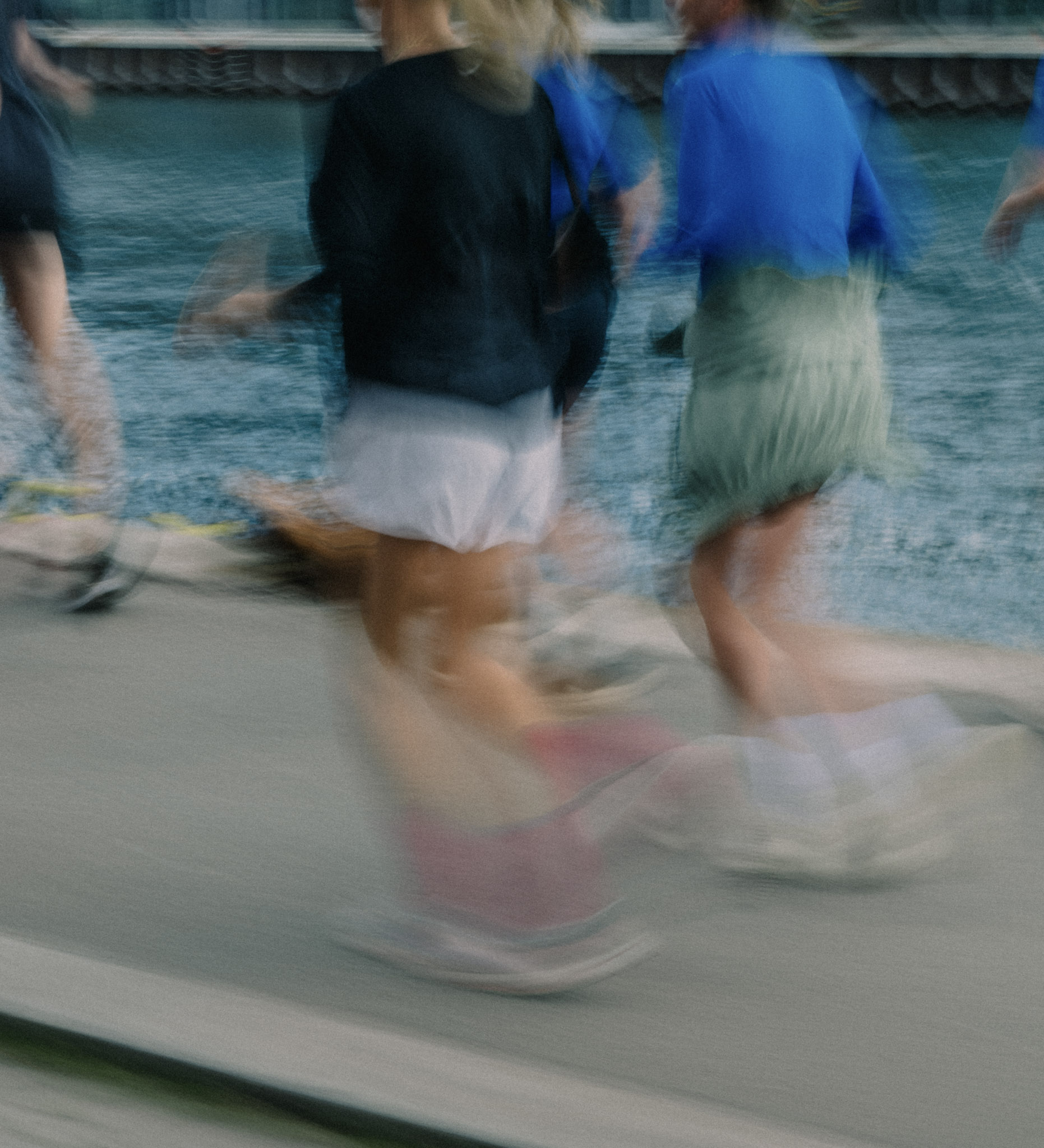 Group of people running by the habour. 