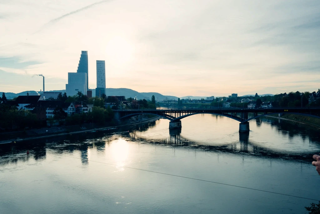 Basel skyline at sunset with the Roche towers and a bridge over the Rhine, Switzerland