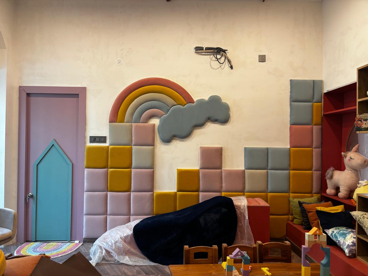 Bright yellow classroom doors create a cheerful contrast against the blue wainscoting, creating a vibrant journey for students between classes.