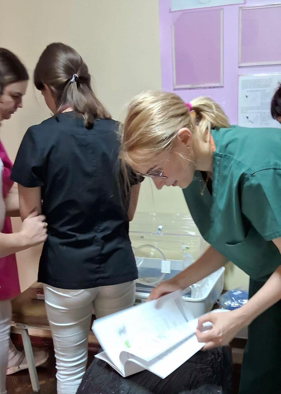 Clinical staff preparing a mobile incubator system.