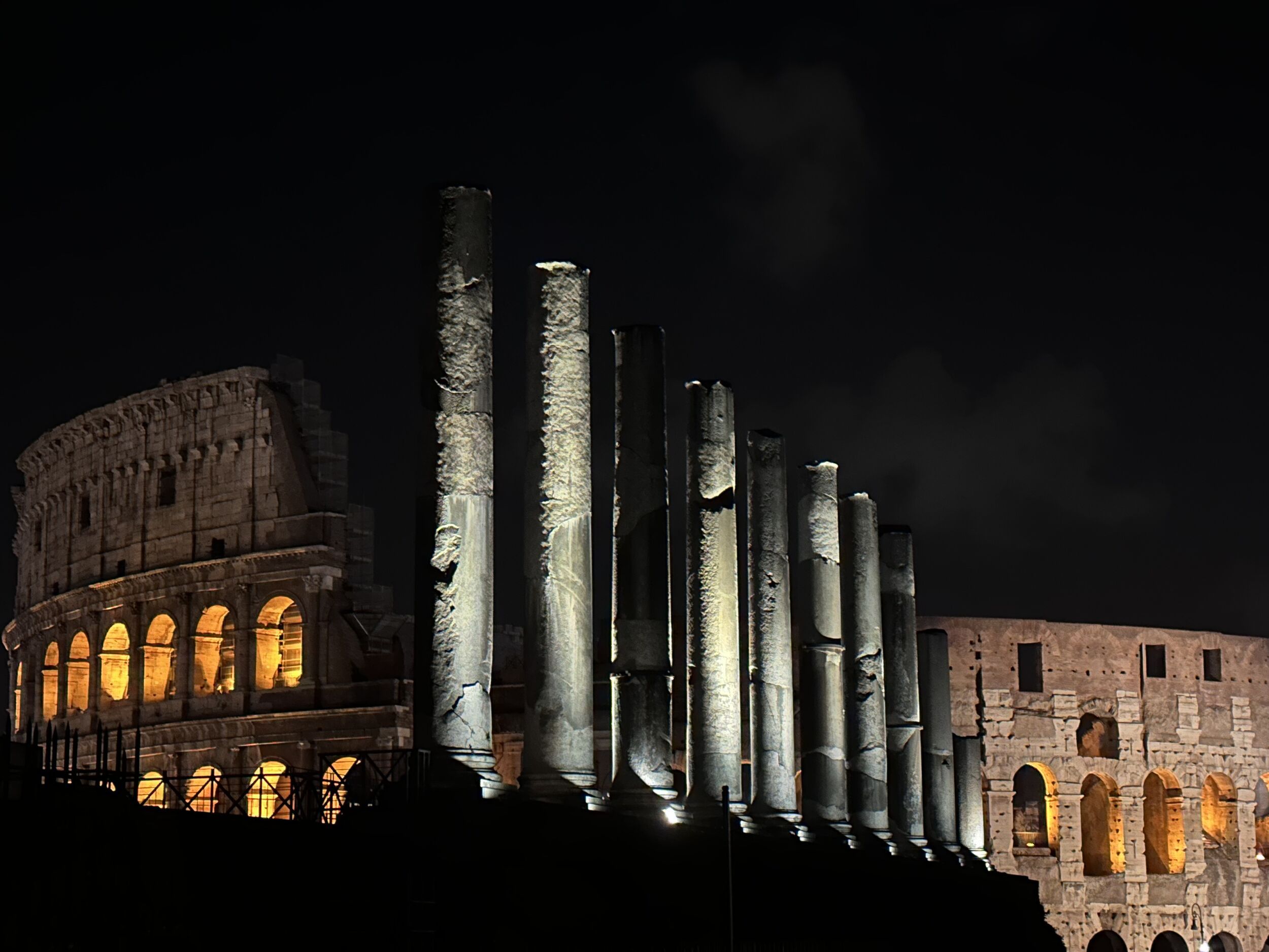 Cobblestone climb of Via di San Bonaventura al Palatino from the Arco di Costantino at night, Rome