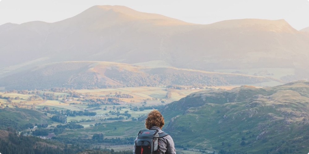 person sitting on top of a hill