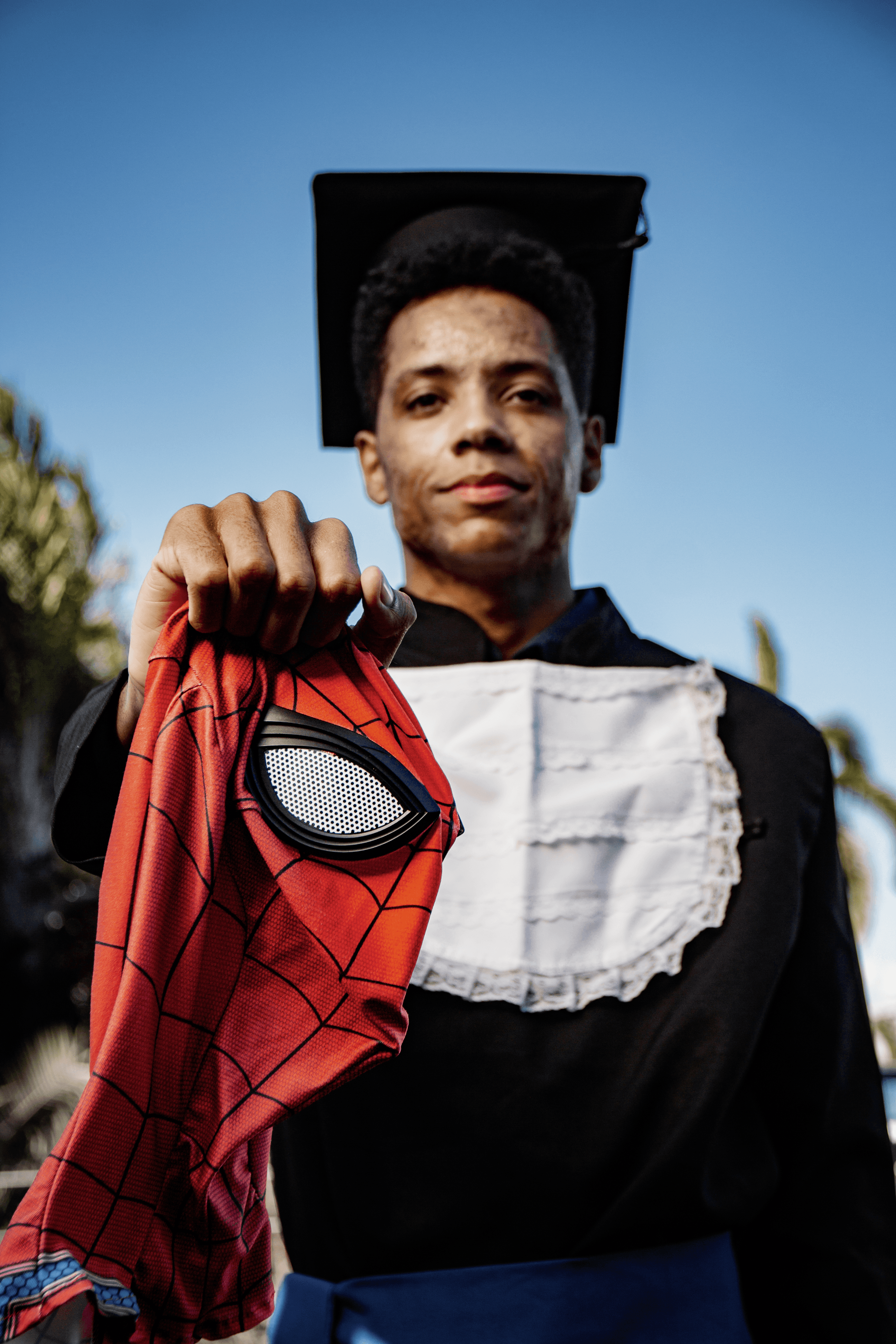 Stylish individual with platinum blonde hair, sunglasses, and leather outfit