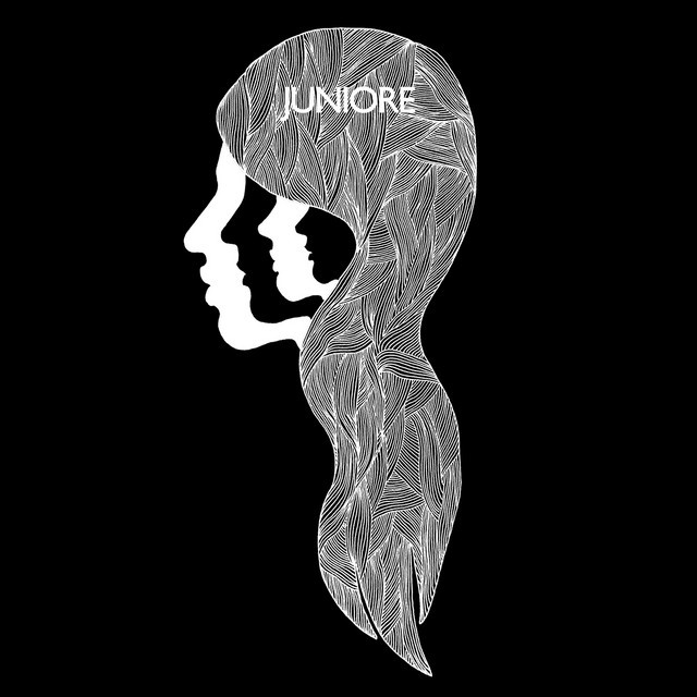 a black piano sitting in front of a wooden wall