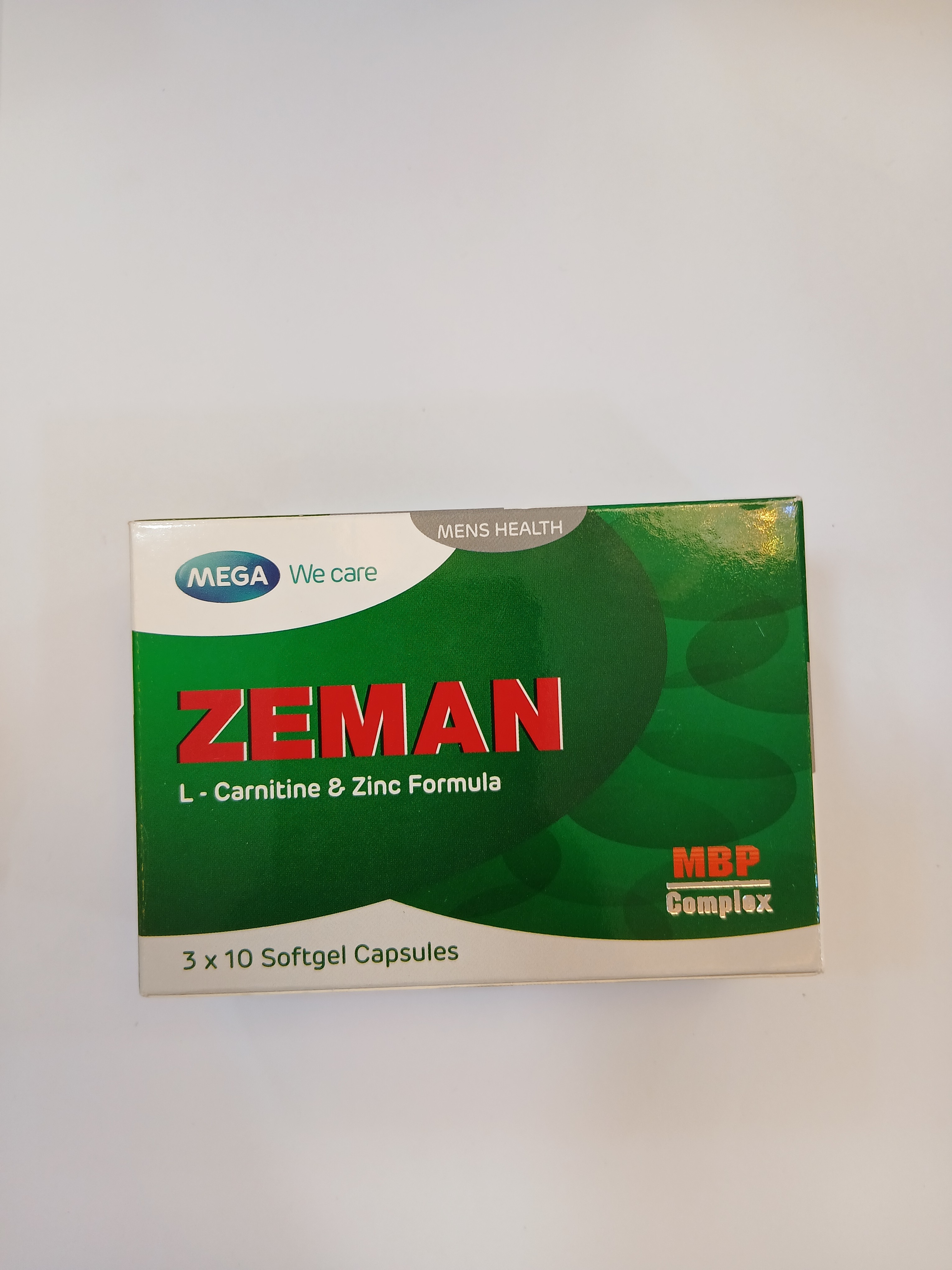 A green and white cardboard box packaging contains three strips of ten softgel capsules each, labeled with text including "L-Carnitine & Zinc Formula" and "MBP Complex.