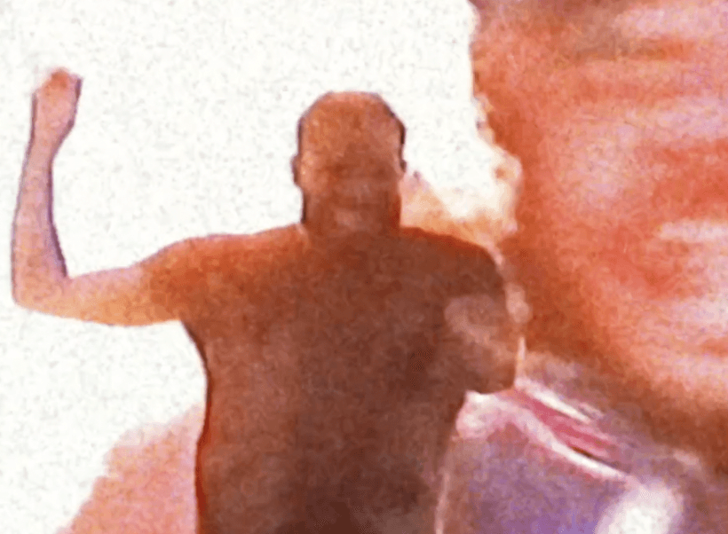 Woman in black outfit sitting on bar stool, leg extended