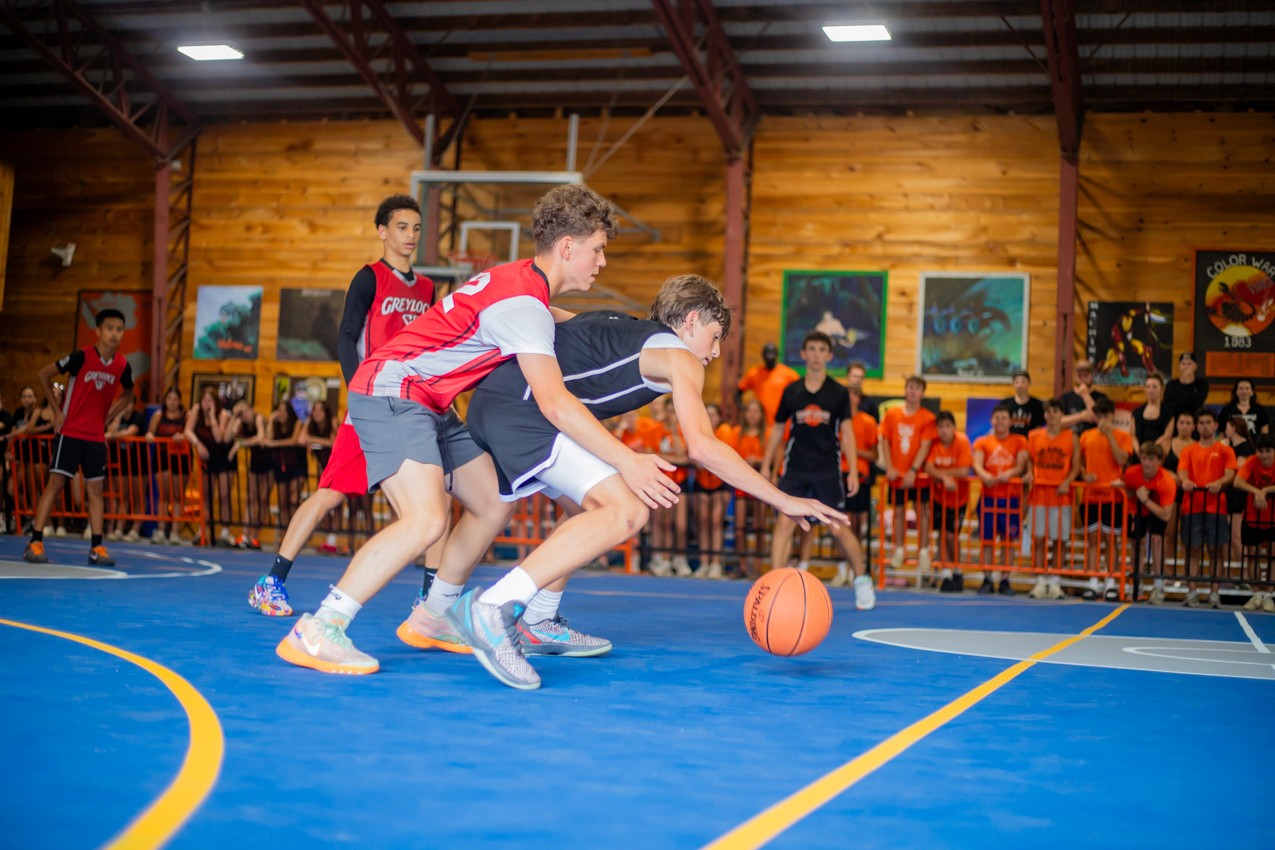 Campers playing an intercamp basketball tournament game in the gym