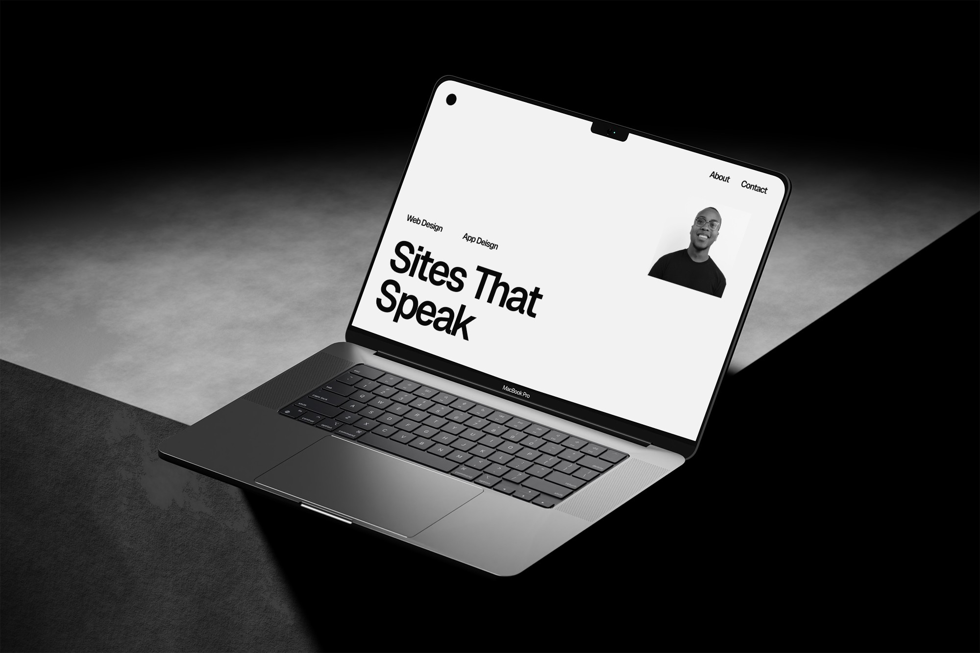 Laptop on concrete, website on screen